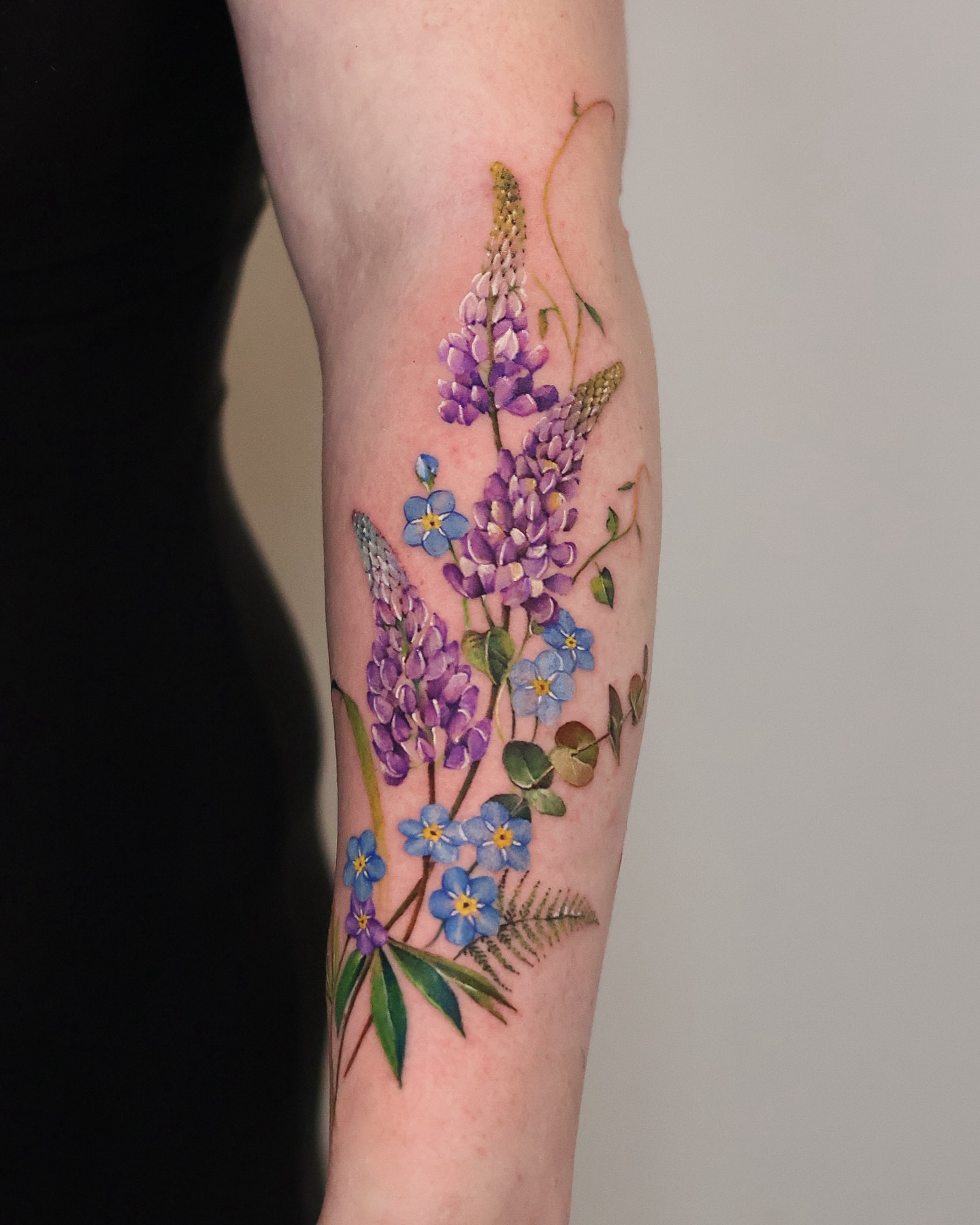 Wildflowers realism tattoo on the forearm by 𝒀𝒖𝒏𝒎𝒊 𝑷𝒂𝒓𝒌