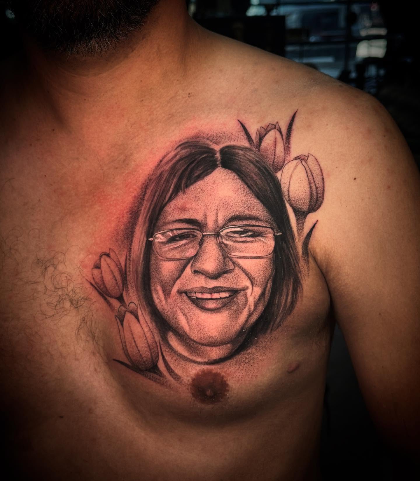 Portrait realism tattoo on the chest by Carlos Lujan