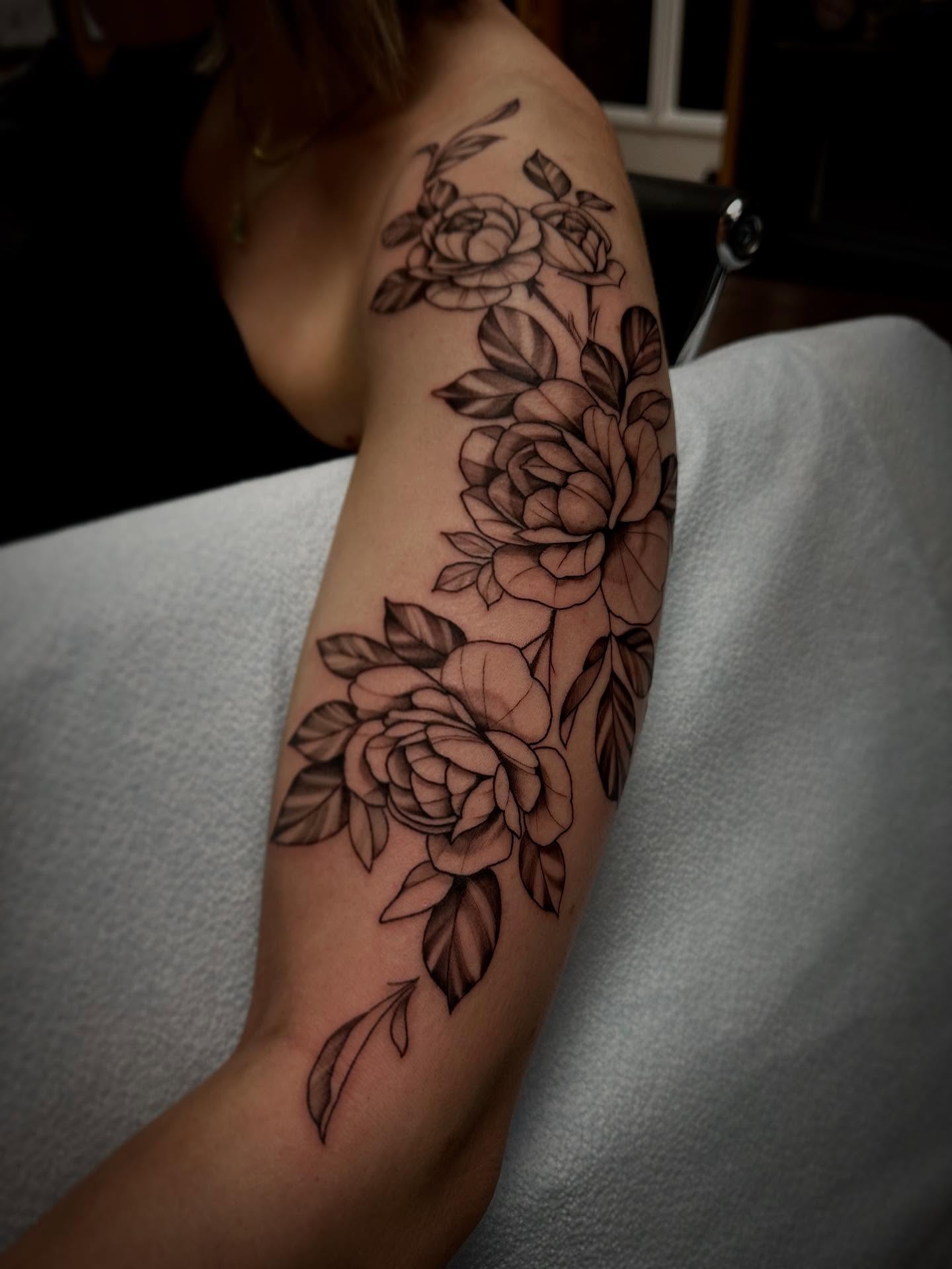 Floral bouquet black and grey tattoo on the forearm by Sebastian Livingston