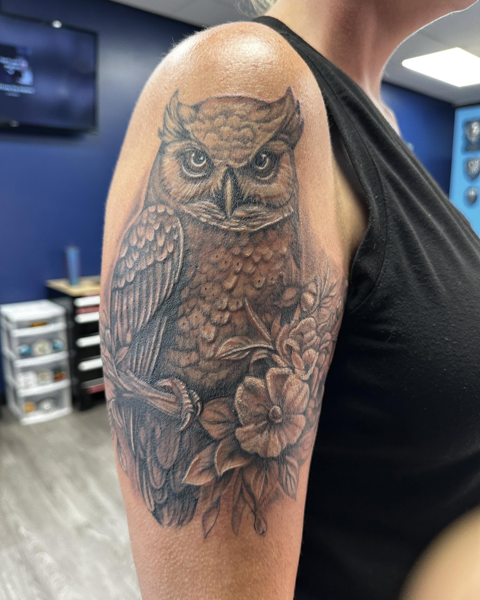 Owl realism tattoo on the upper arm by Nathan Froehlich