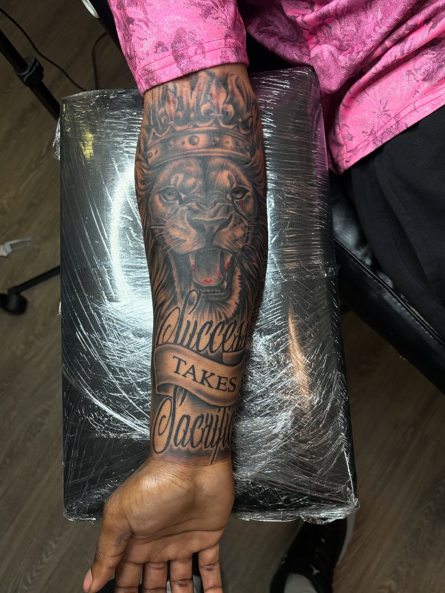 Lion crown realism tattoo on the forearm by Vonte Seay