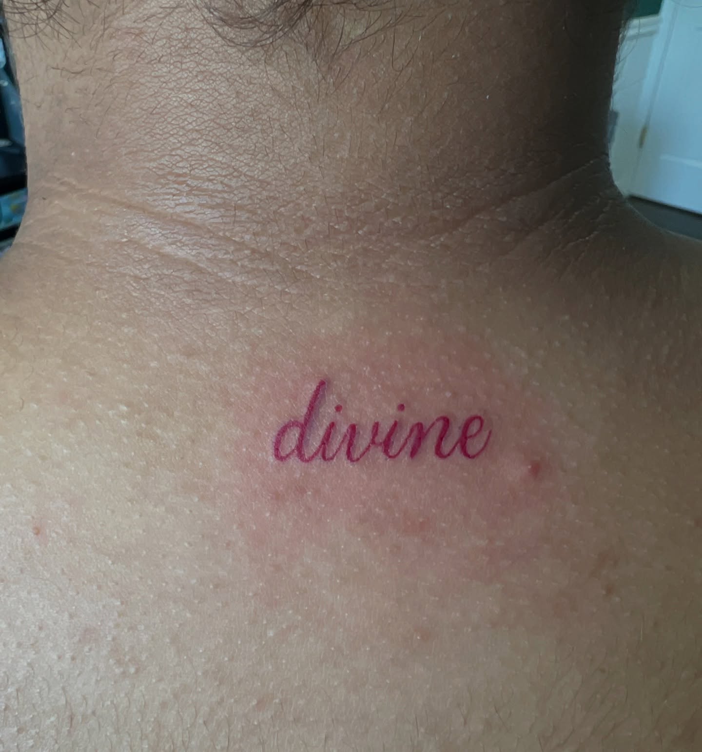 Divine lettering script tattoo on the neck by Cortnie, Nashville, Tennessee