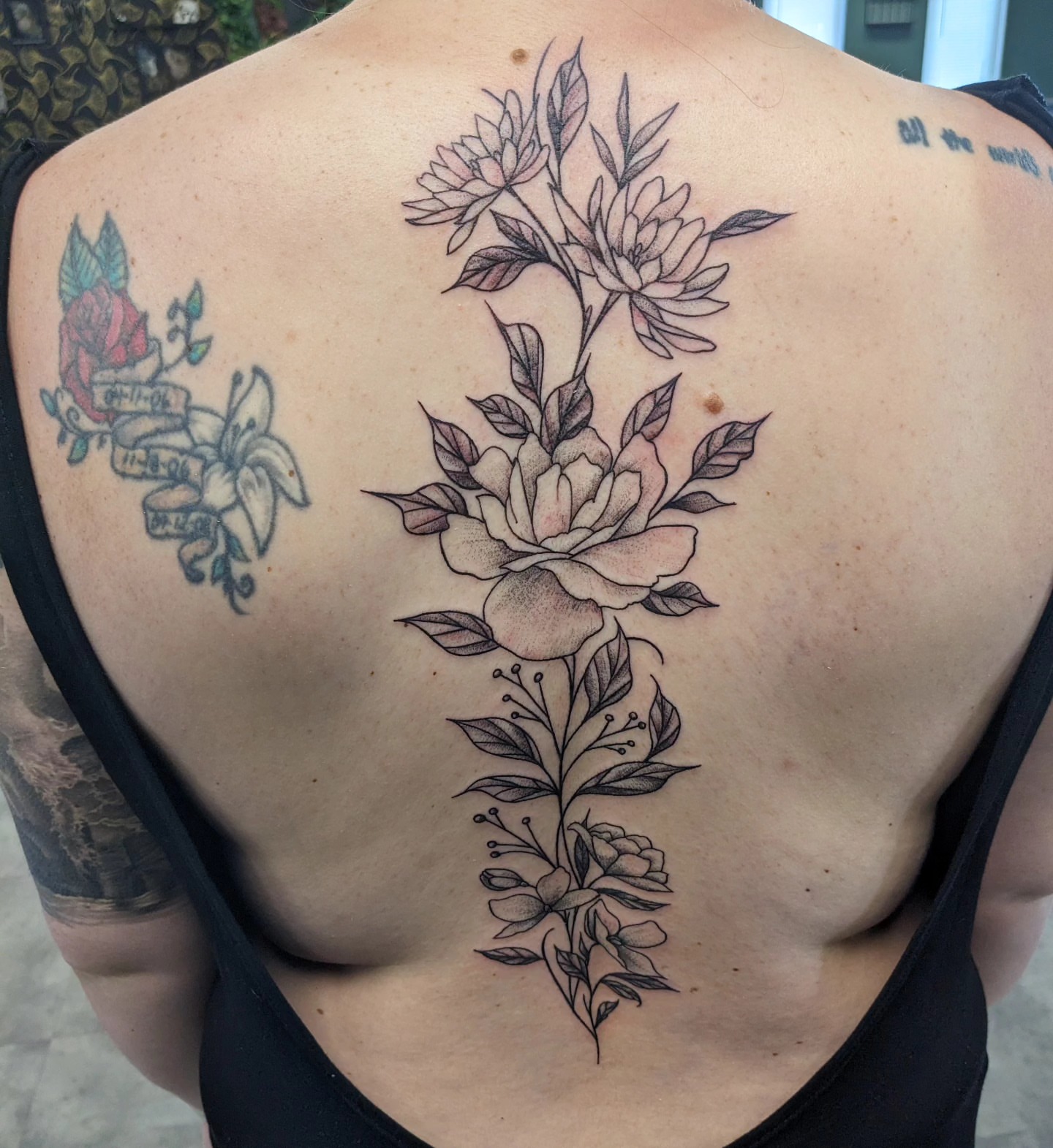 Floral arrangement realism tattoo on the back by Ed Gonzalez