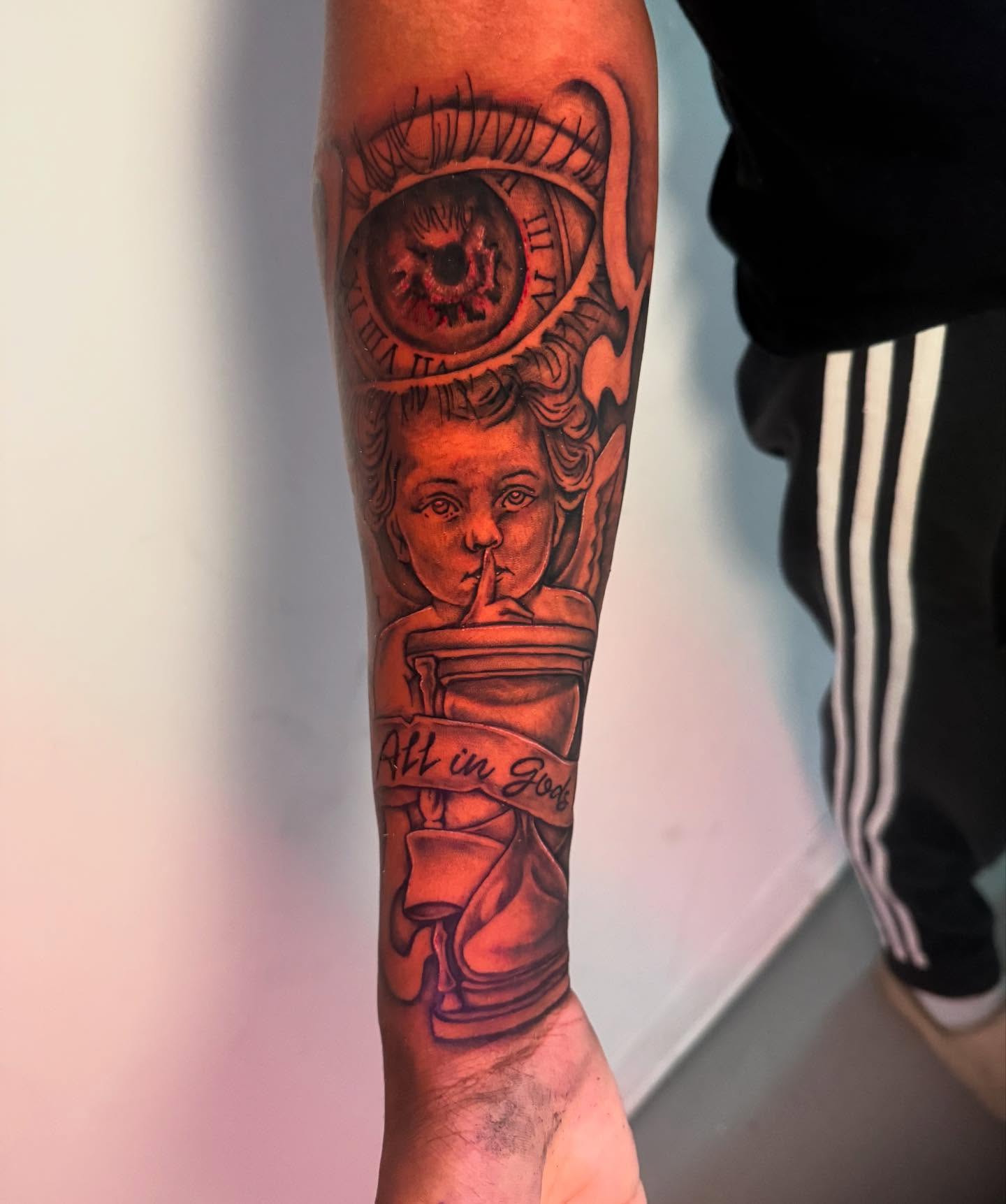 Statue with eye realism tattoo on the forearm by The Ink Guru.