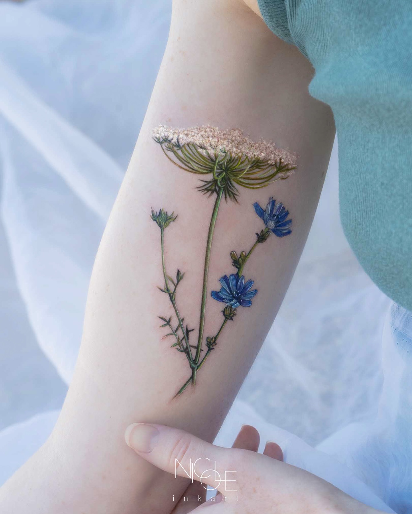 Blue flowers realism tattoo on the forearm by 𝐍𝐈𝐂𝐎𝐋𝐄 𝐋