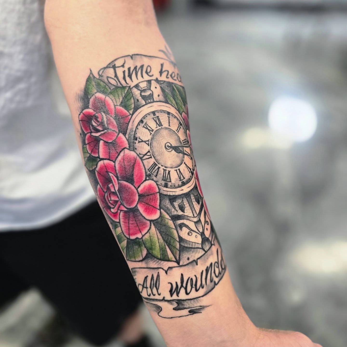 Clock and roses American traditional tattoo on the forearm by Jon Griffin, Maryville, Tennessee
