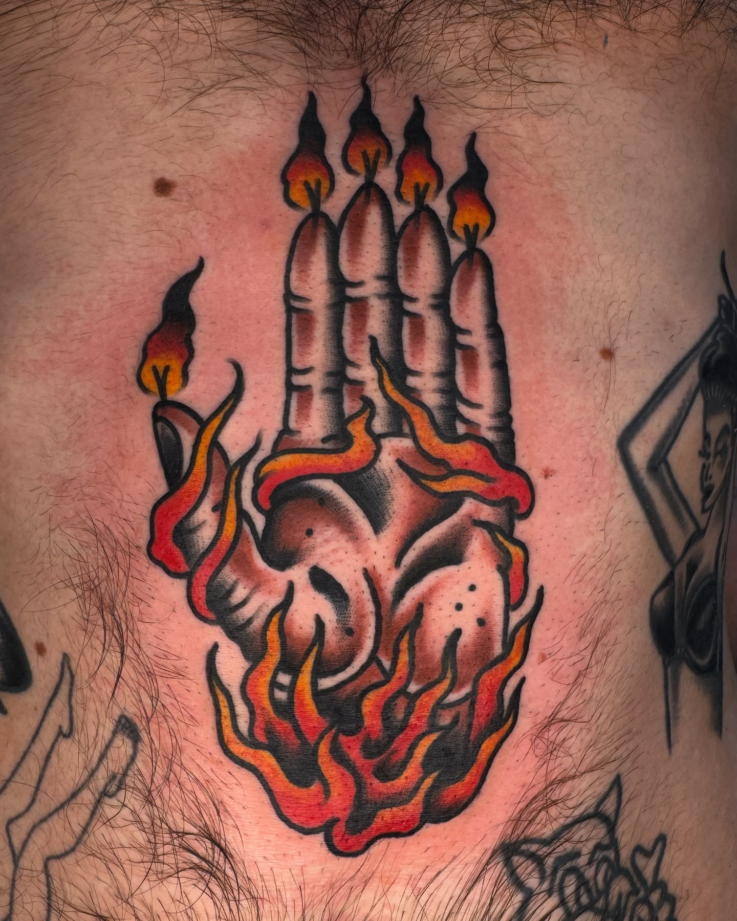 Burning hand with candles American traditional tattoo on the thigh by Tony Kaplan