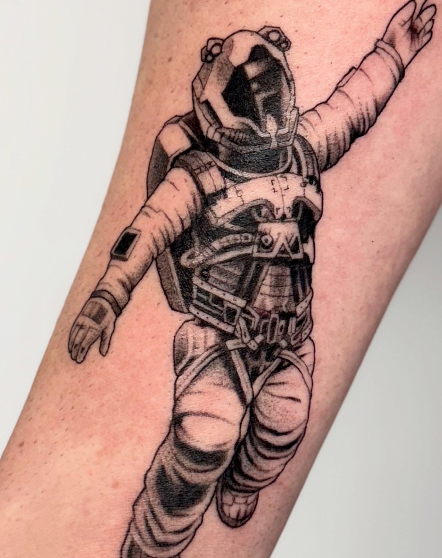 Astronaut realism tattoo on the forearm by Erin Blaney
