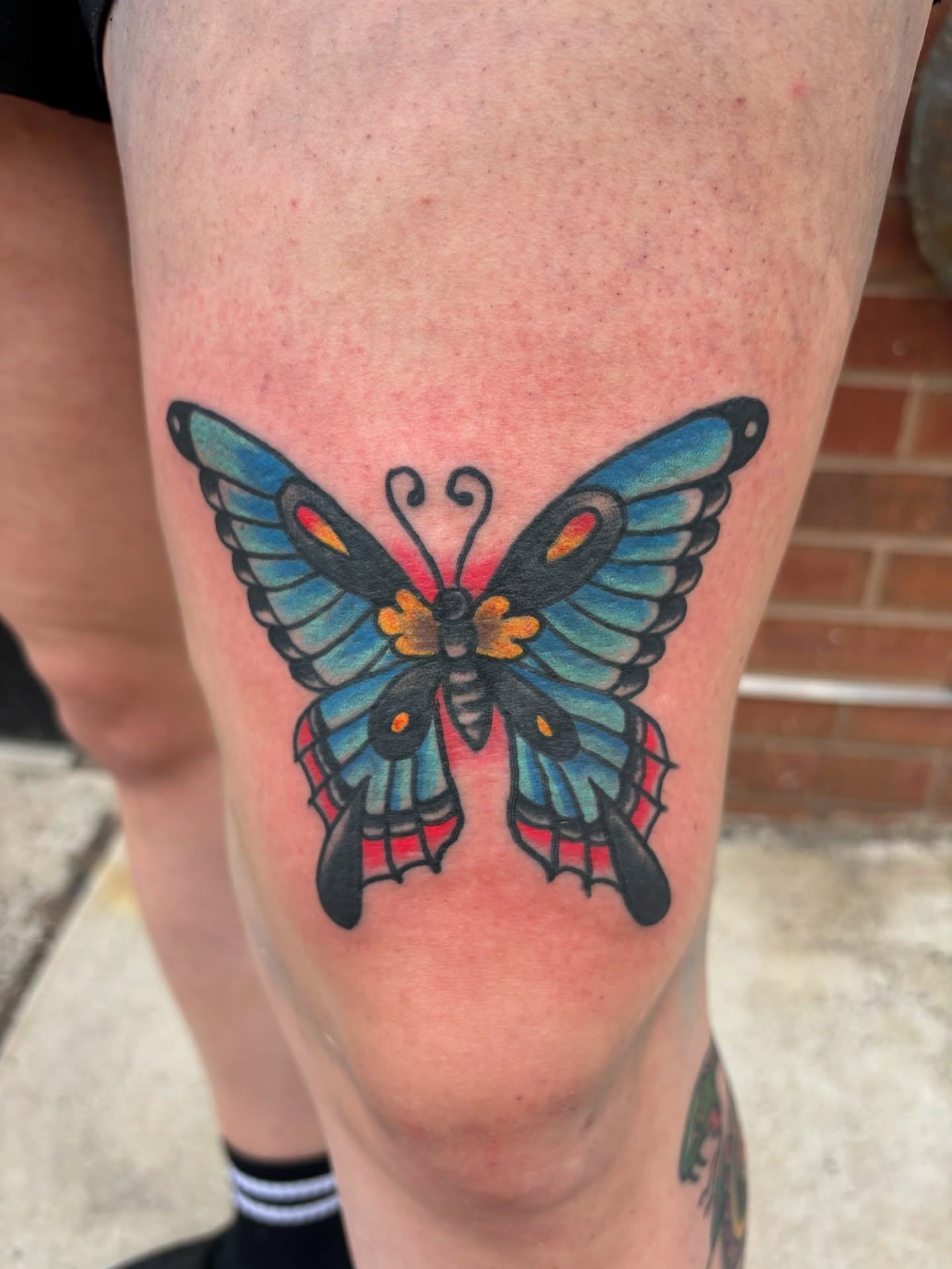 Butterfly American traditional tattoo on the thigh by Francis Cassidy
