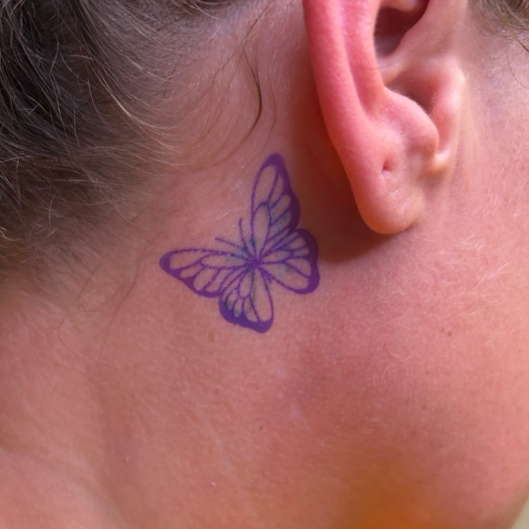 Butterfly fine line tattoo on the neck by Ashley Lambert