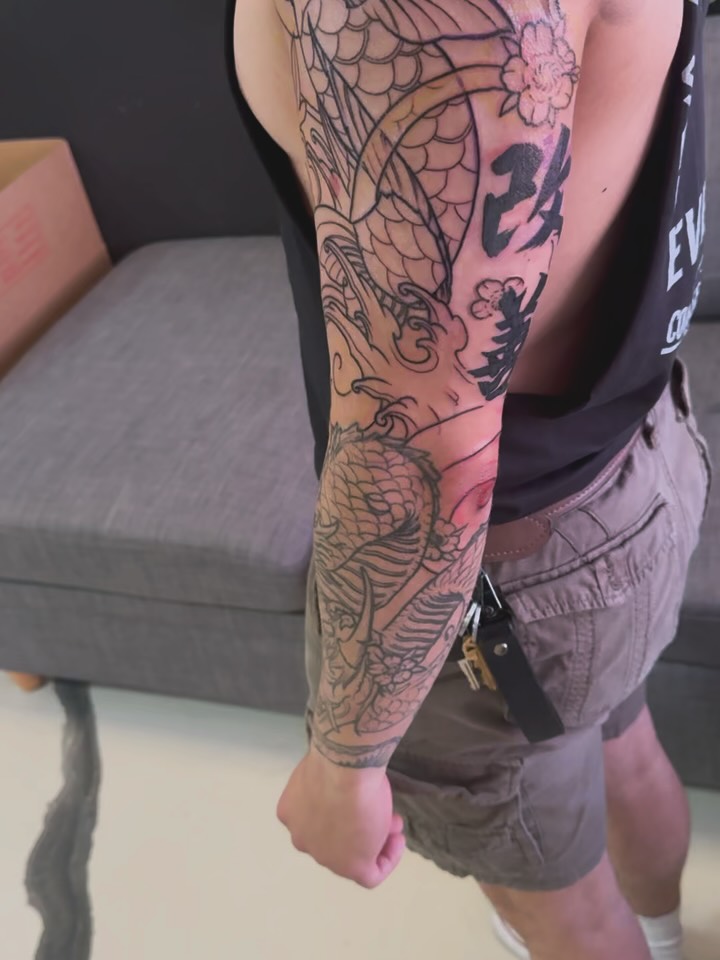Dragon and cherry blossoms japanese irezumi tattoo on the forearm by Joseph Marshall
