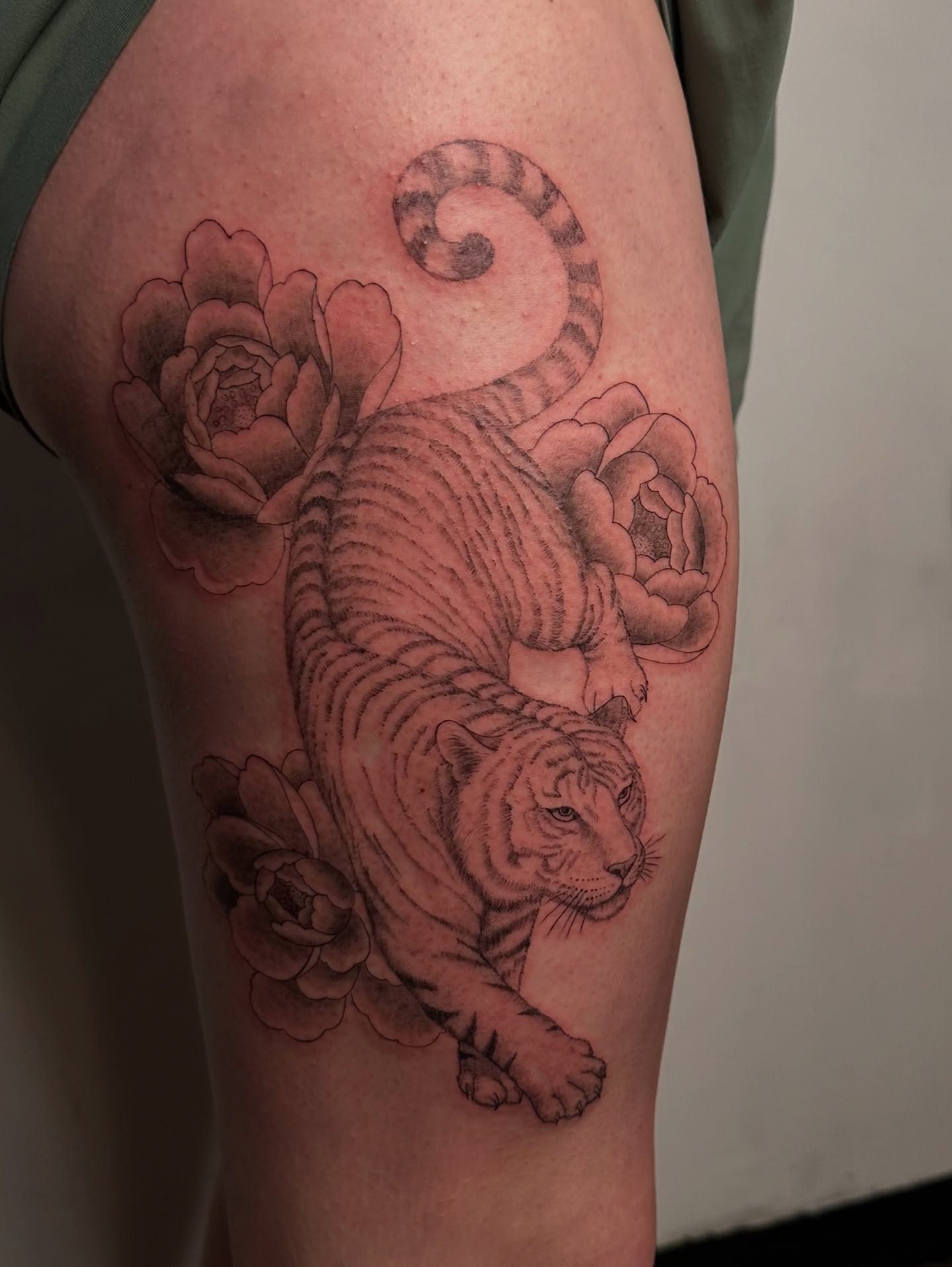 Tiger and flowers realism tattoo on the thigh by Piccolino, Cambridge, Massachusetts