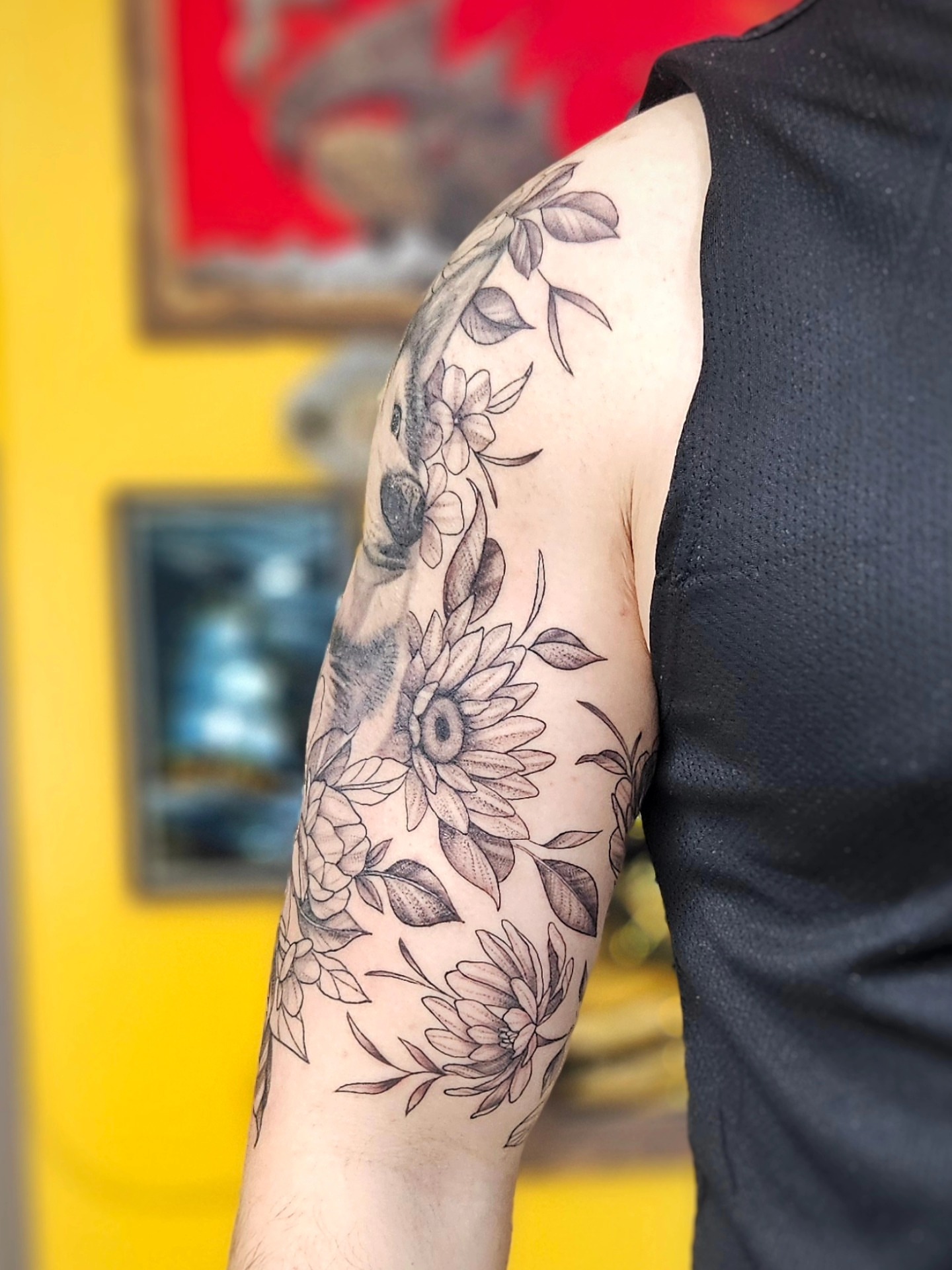 Sunflower and floral bouquet black and grey tattoo on the forearm by Jordanna Pearl
