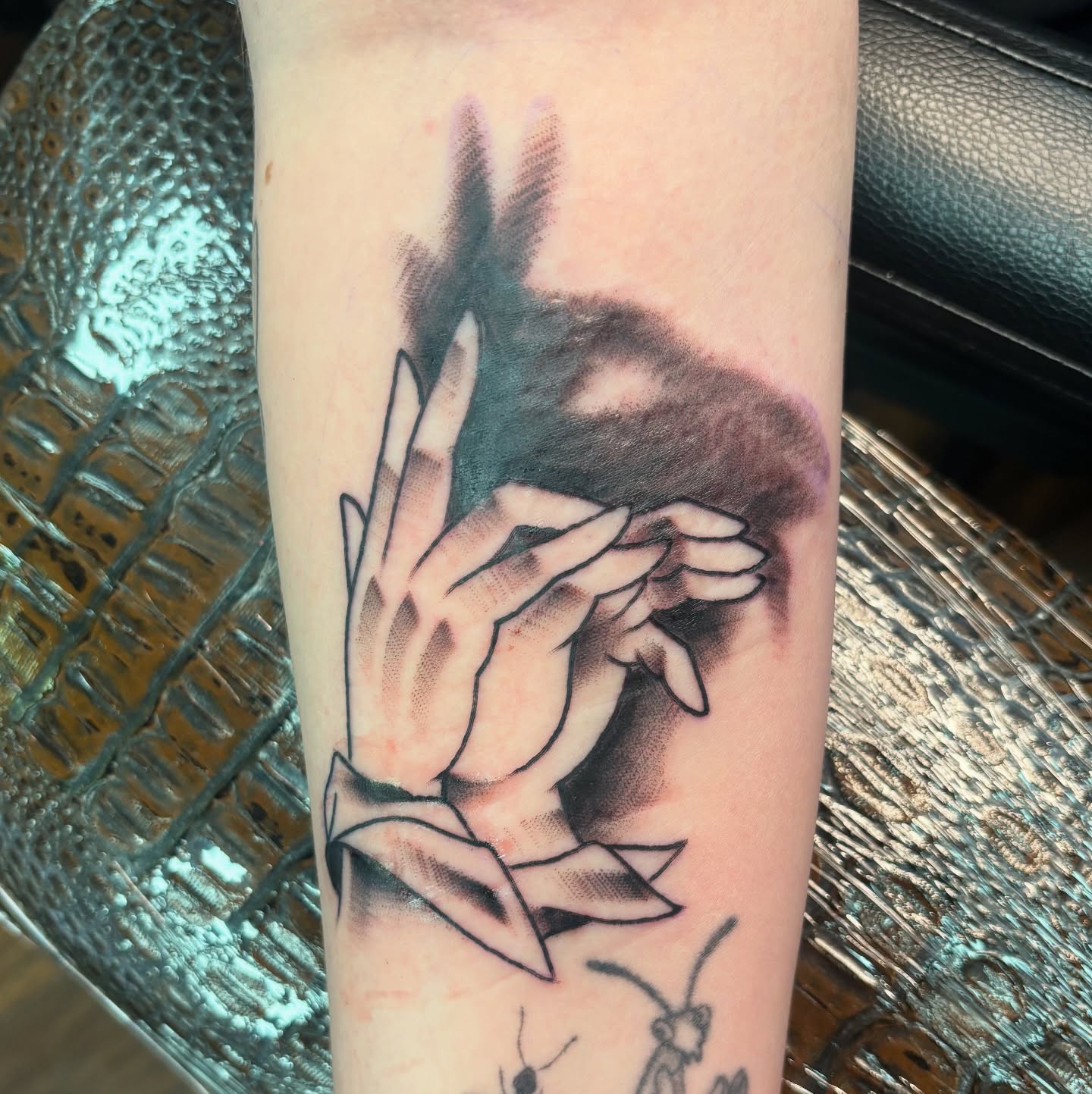 Hands covering face realism tattoo on the forearm by Jordan Wray
