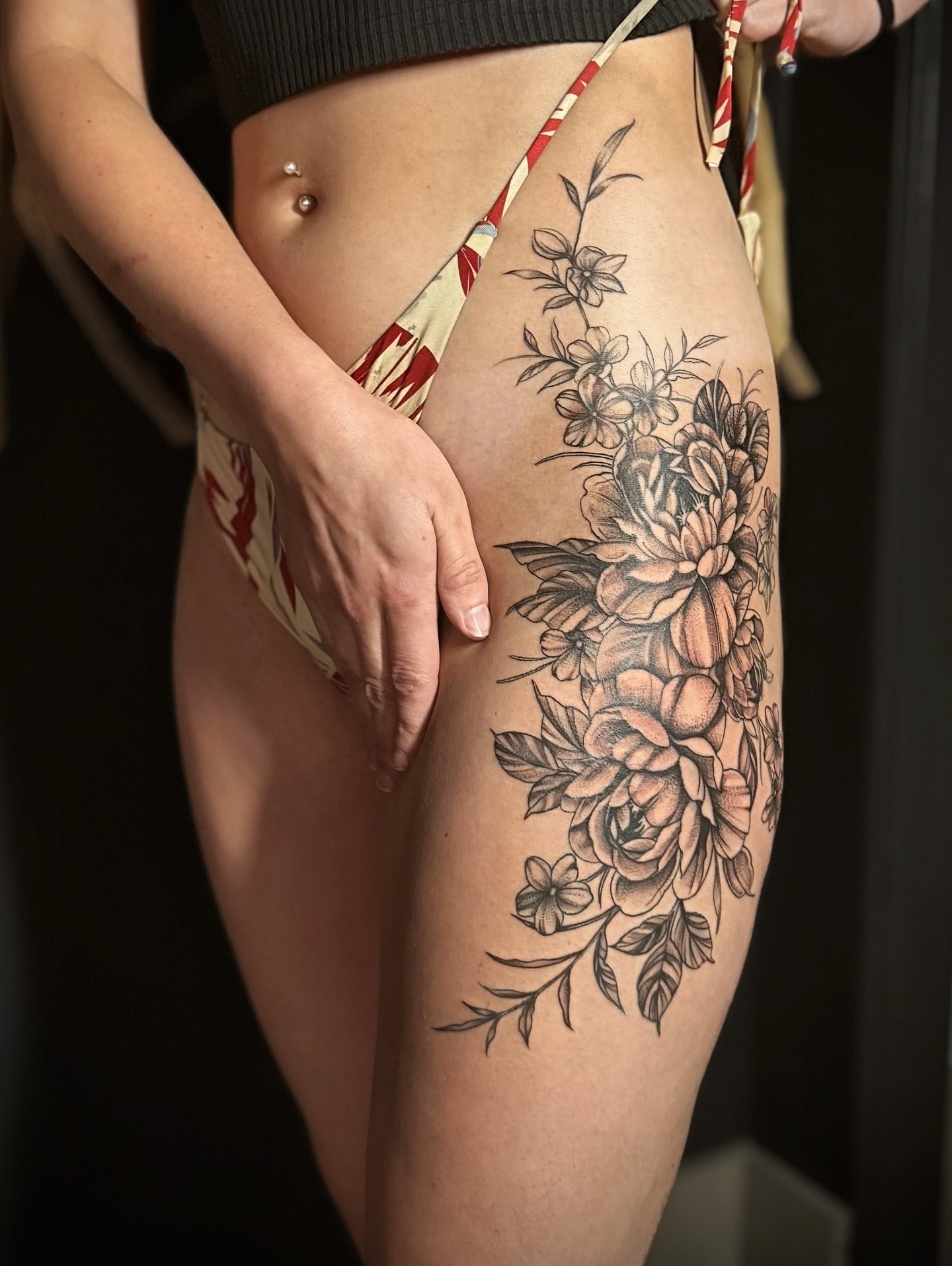 Floral bouquet black and grey tattoo on the thigh by Jewels, St. George, Utah