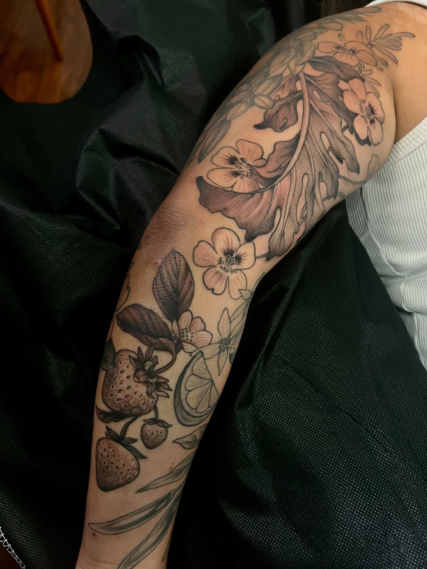 Botanical black and grey tattoo on the forearm by Avrey Simone
