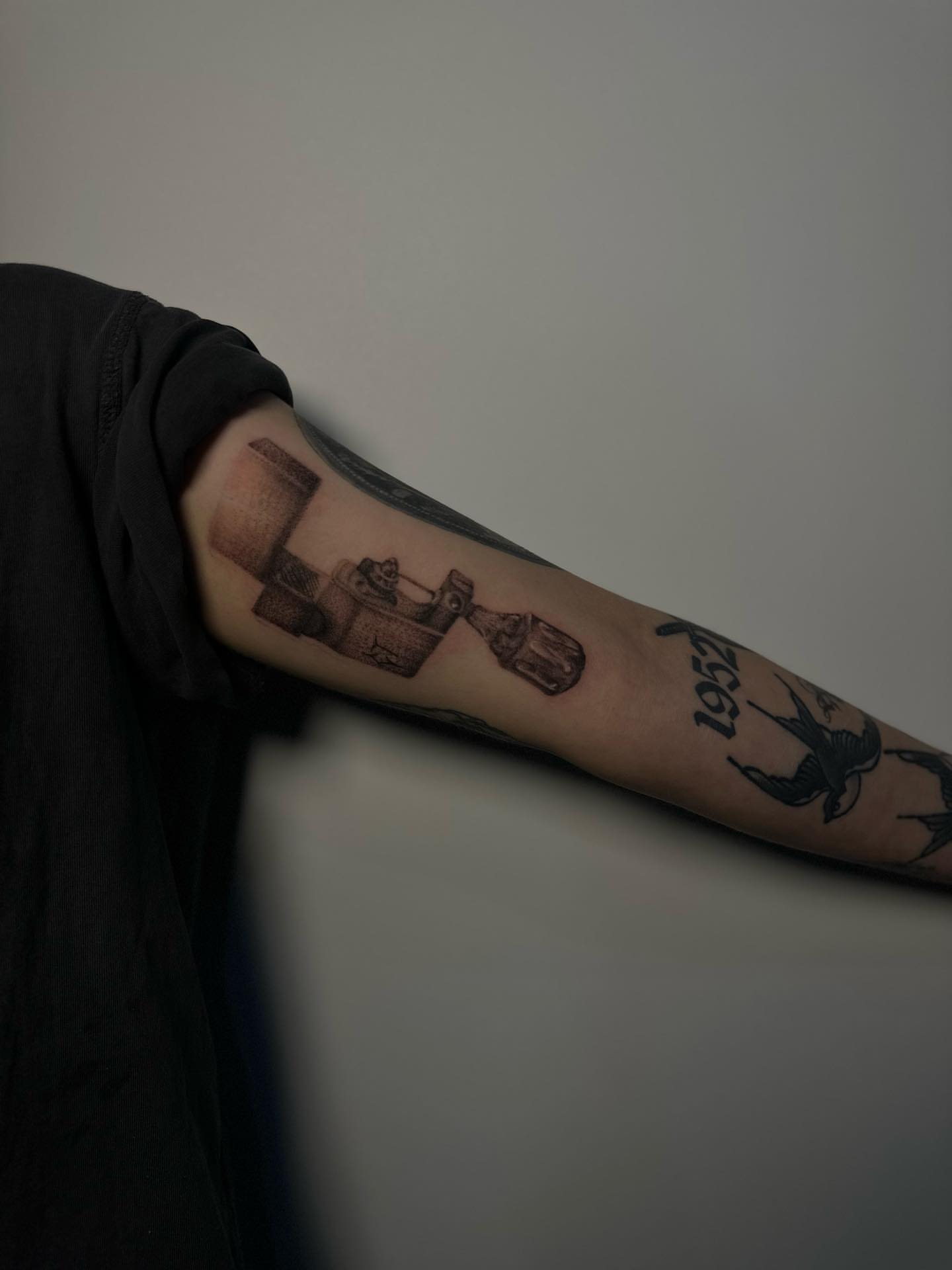 Statue and book black and grey tattoo on the forearm by Lee
