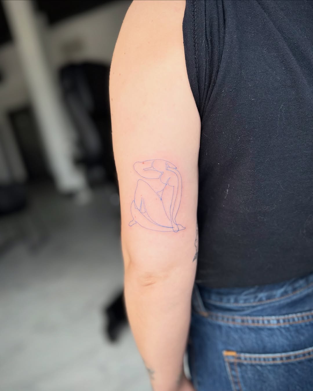 Abstract figure minimalist tattoo on the forearm by Jennifer Fuster