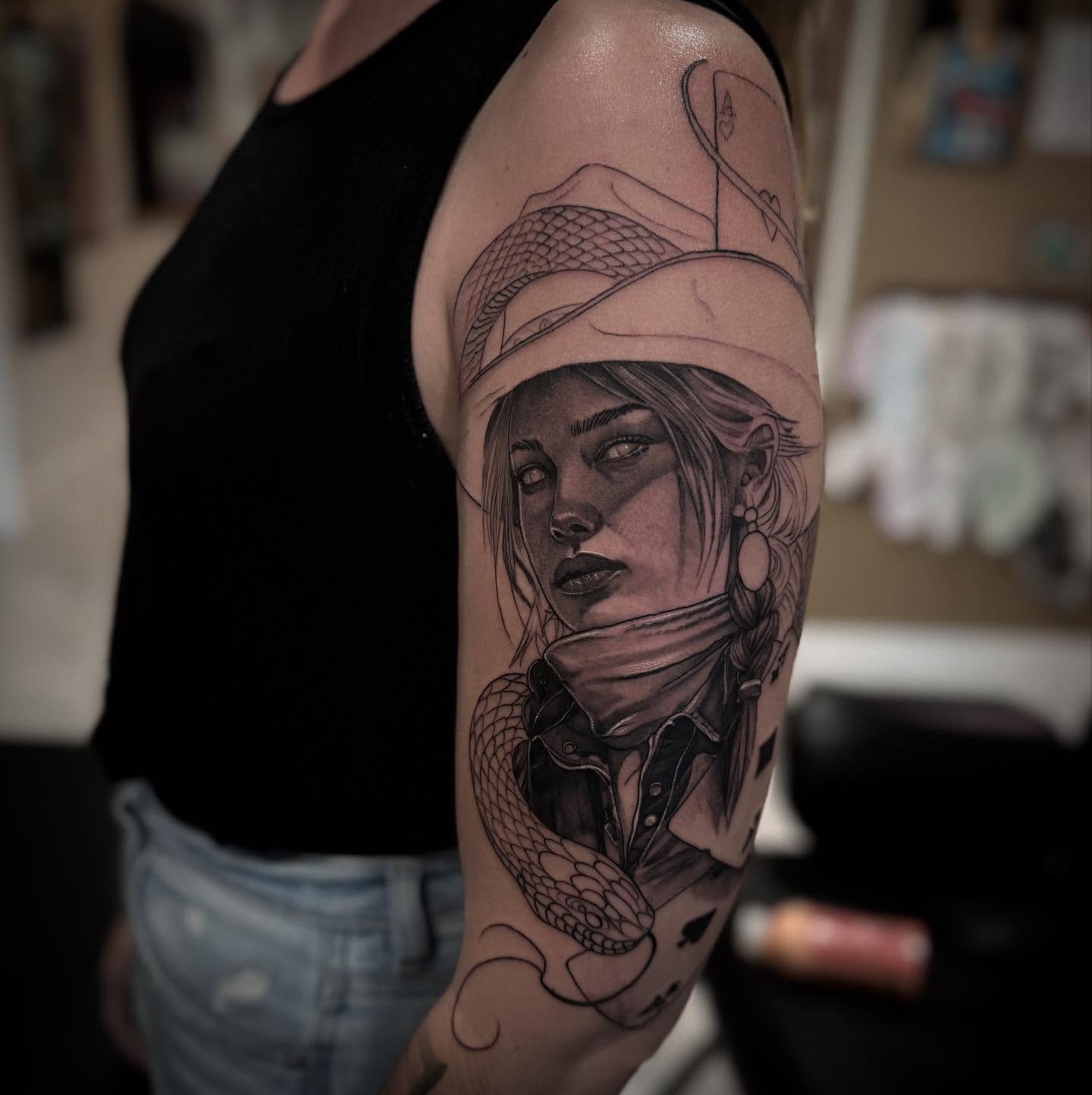 Woman with snake realism tattoo on the forearm by Keith Smith