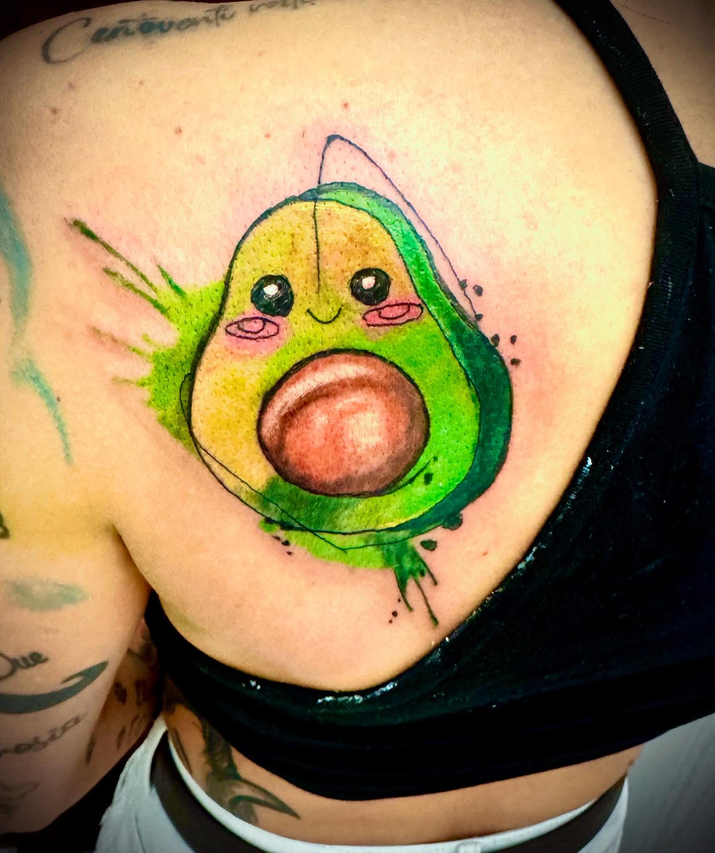 Avocado watercolor tattoo on the chest by Salvador Mendoza, Sesto San Giovanni