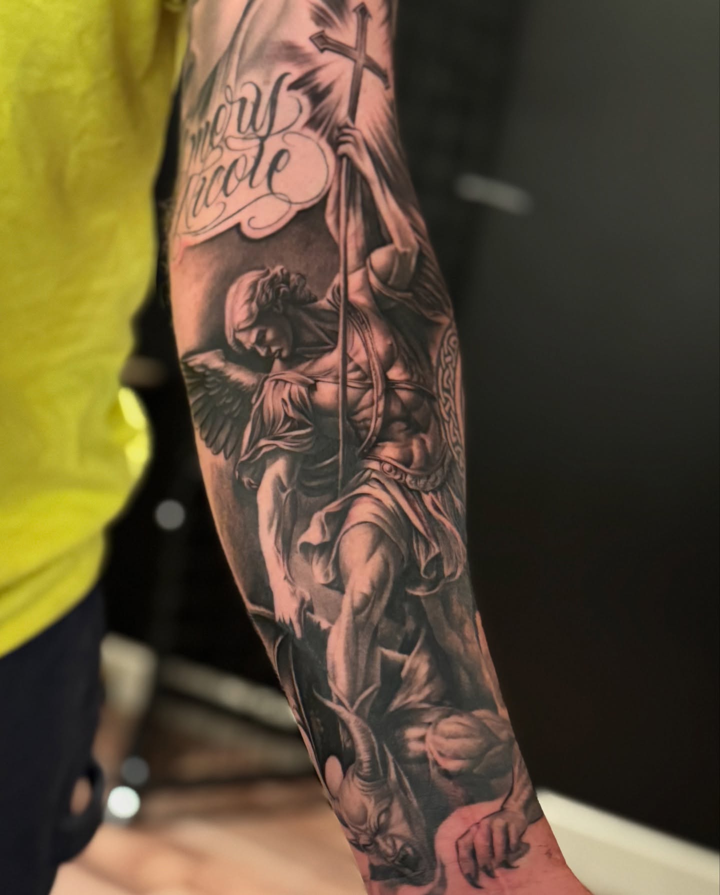 Religious angel realism tattoo on the forearm by tombstone