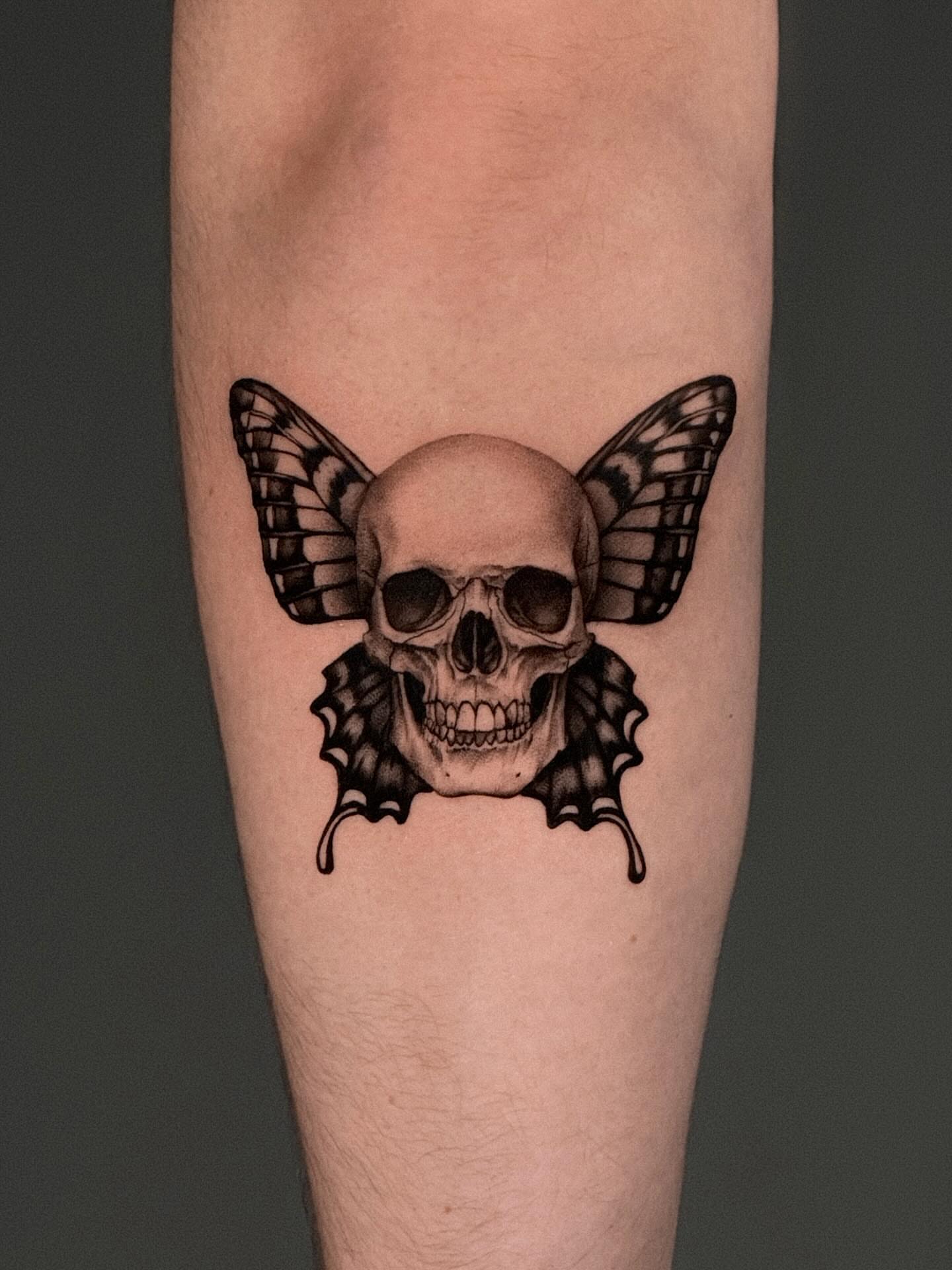 Skull with butterfly wings realism tattoo on the forearm by Henko