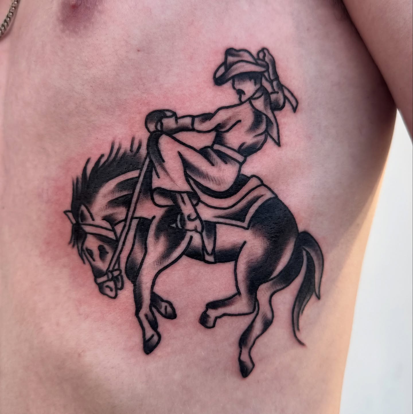 Cowboy riding horse black and grey tattoo on the thigh by Drew🕸️, Phoenix, Arizona