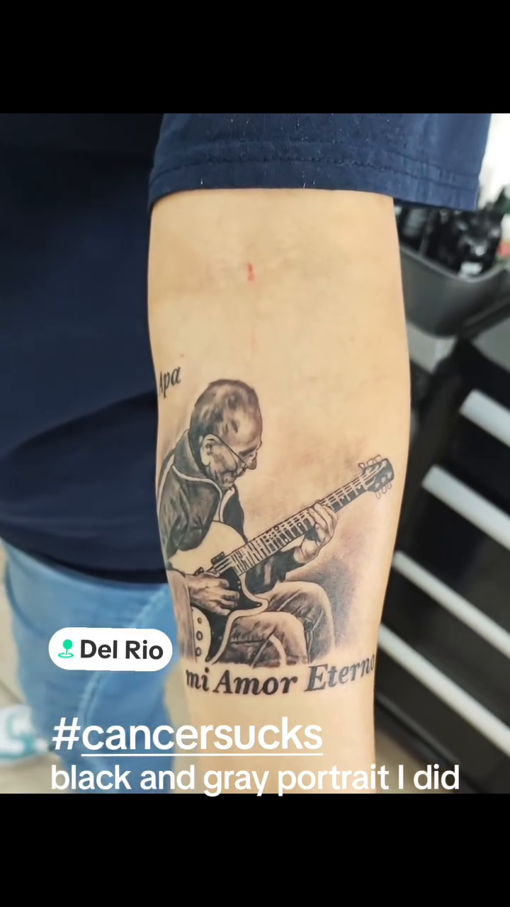 Man playing guitar realism tattoo by Efren Del Rio