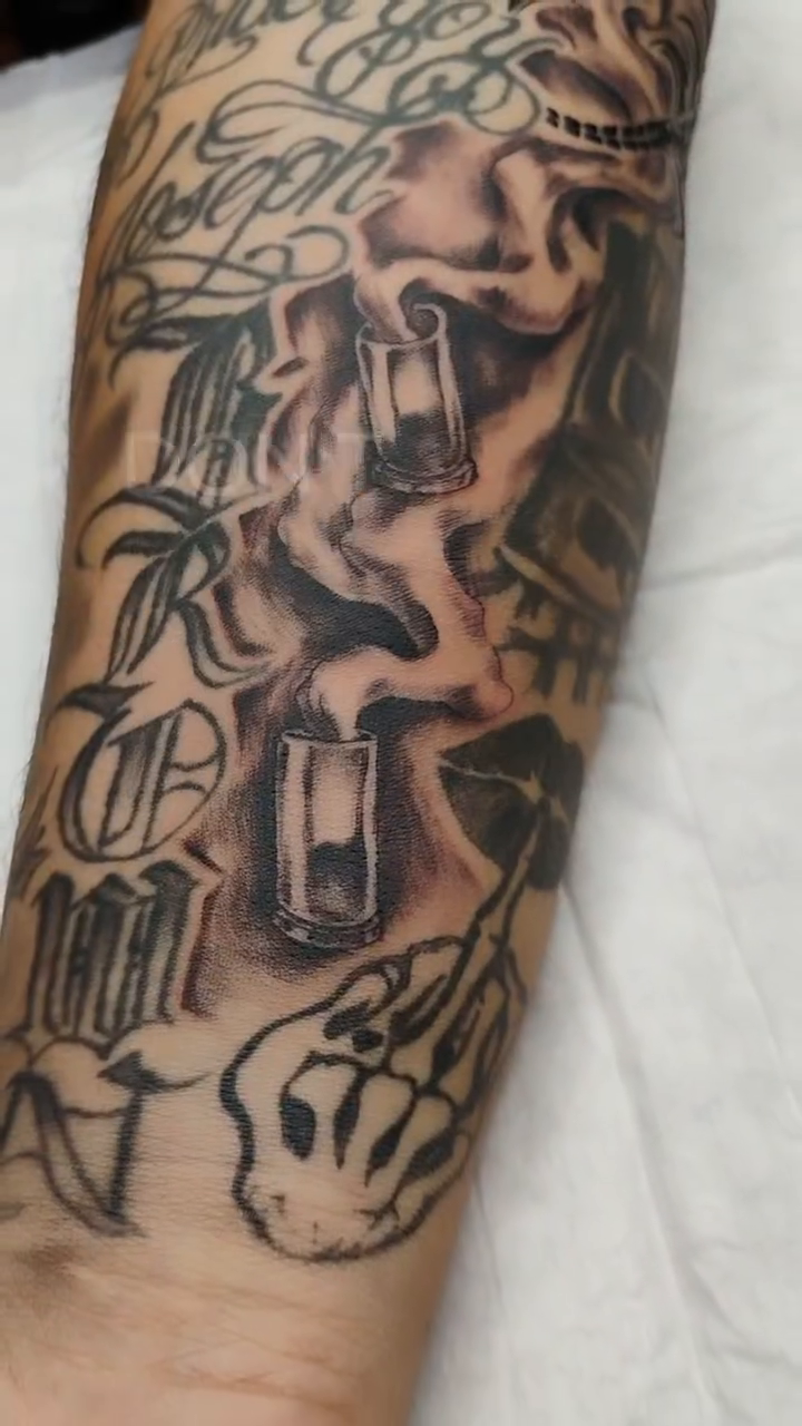 Tattooed arm with lettering and imagery Chicano tattoo on the forearm by Alfredo Sosa