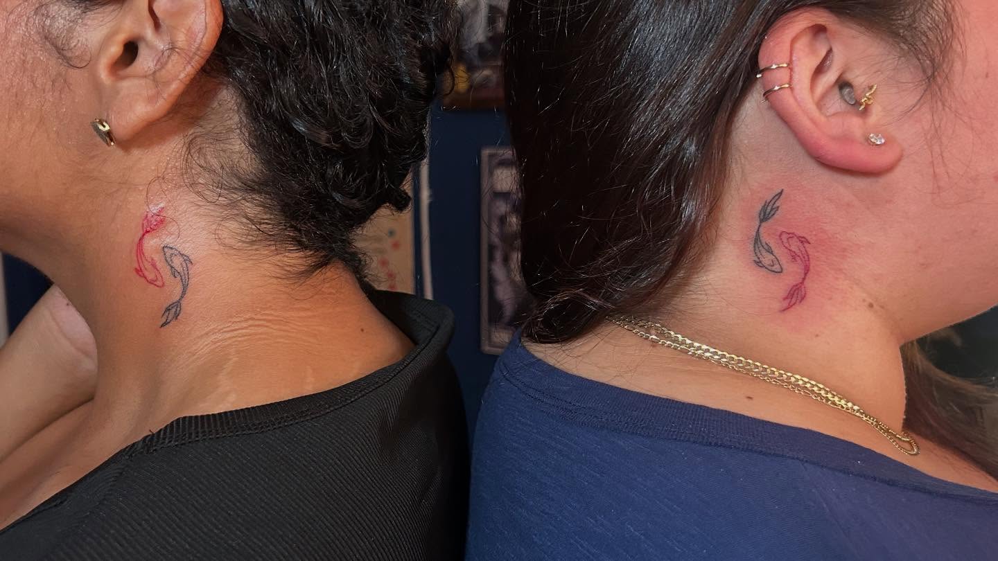 Fishes American traditional tattoo on the neck by Kells