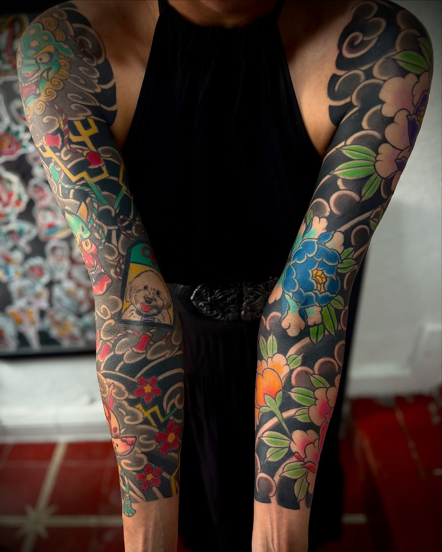 Floral and dog American traditional tattoo on the upper arm by Meza Cruz