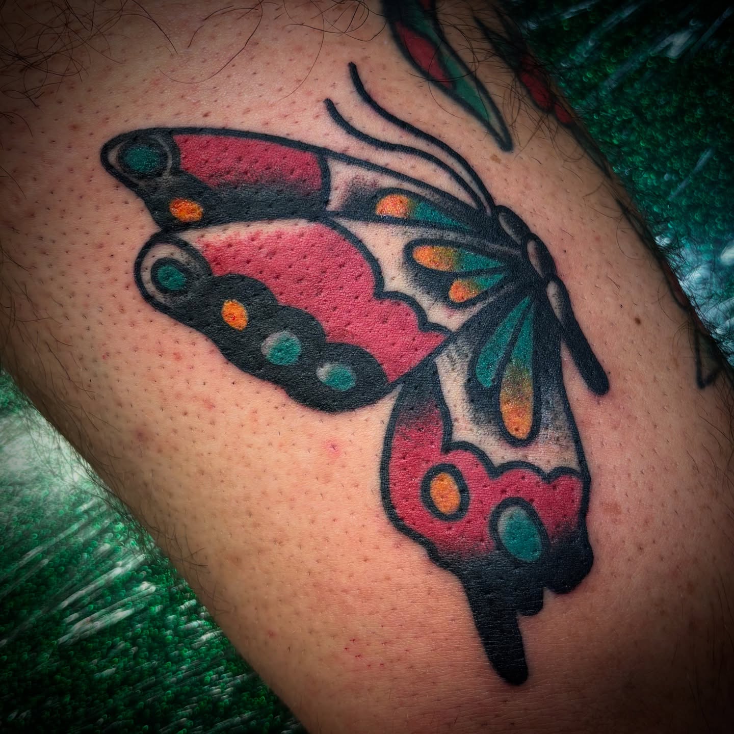 Butterfly American traditional tattoo on the upper arm by Tattoos Las Vegas,NV
