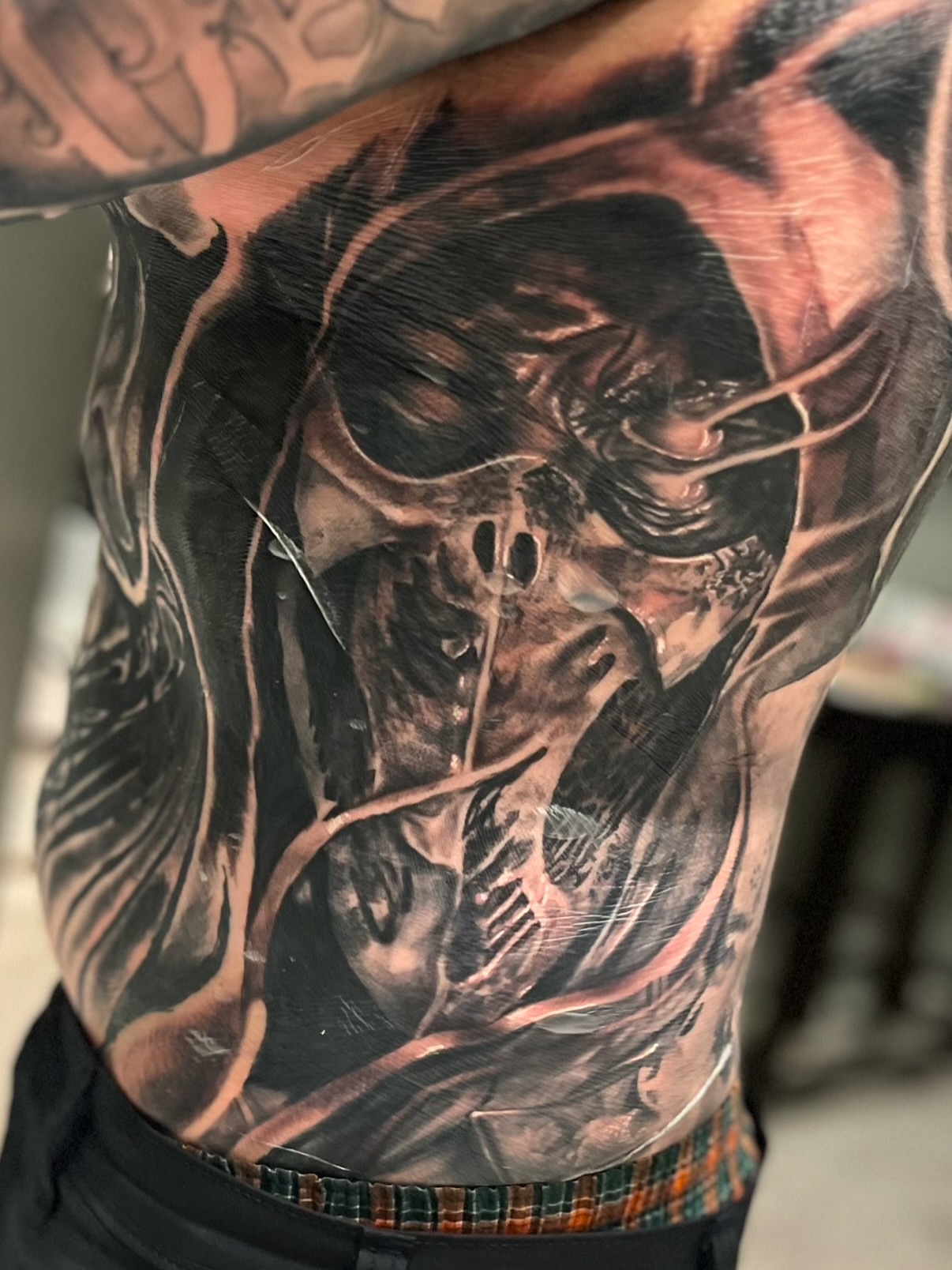 Skull dark realism tattoo on the chest by C.J. Rued