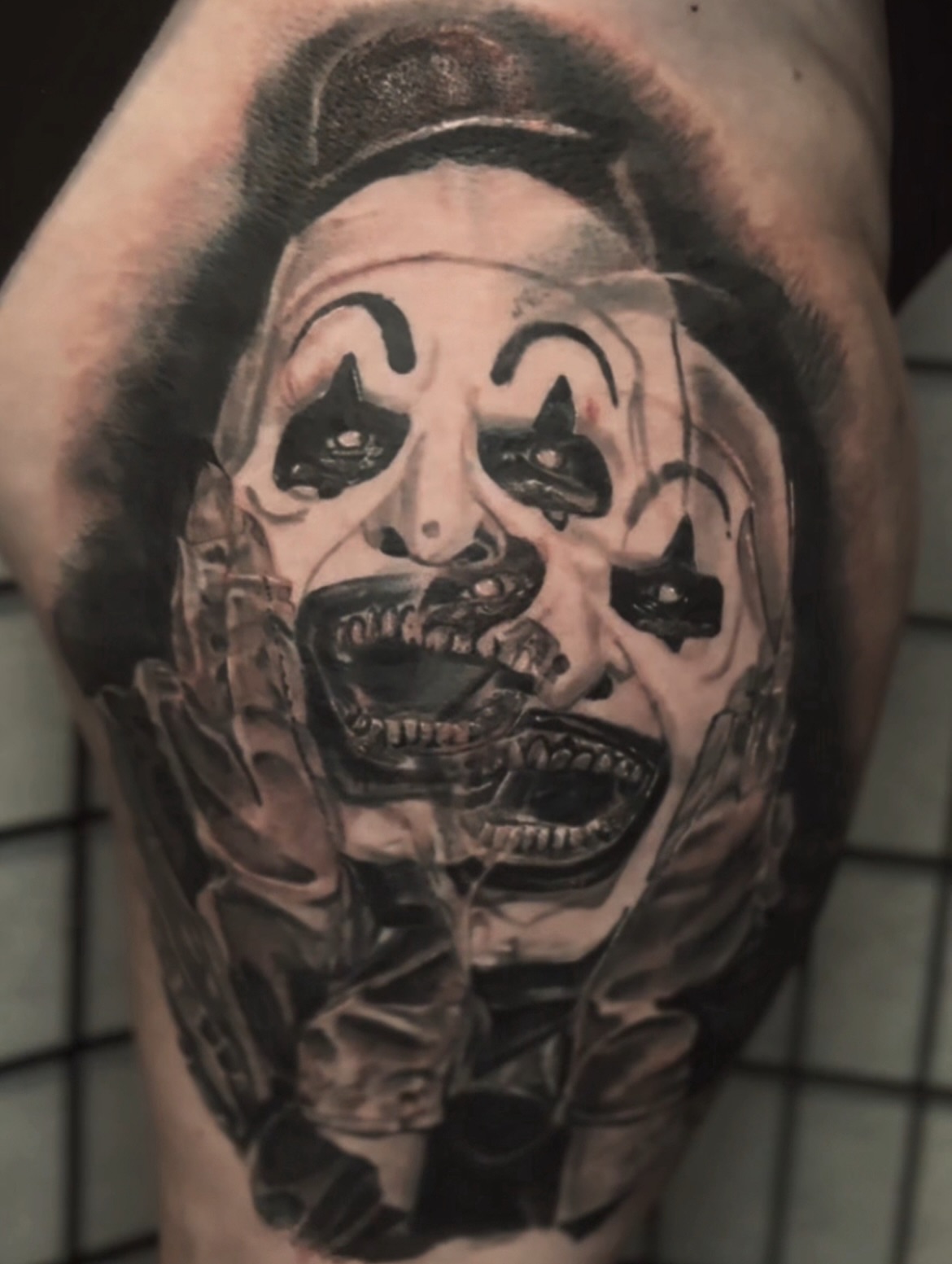 Clown mask realism tattoo on the forearm by C.J. Rued