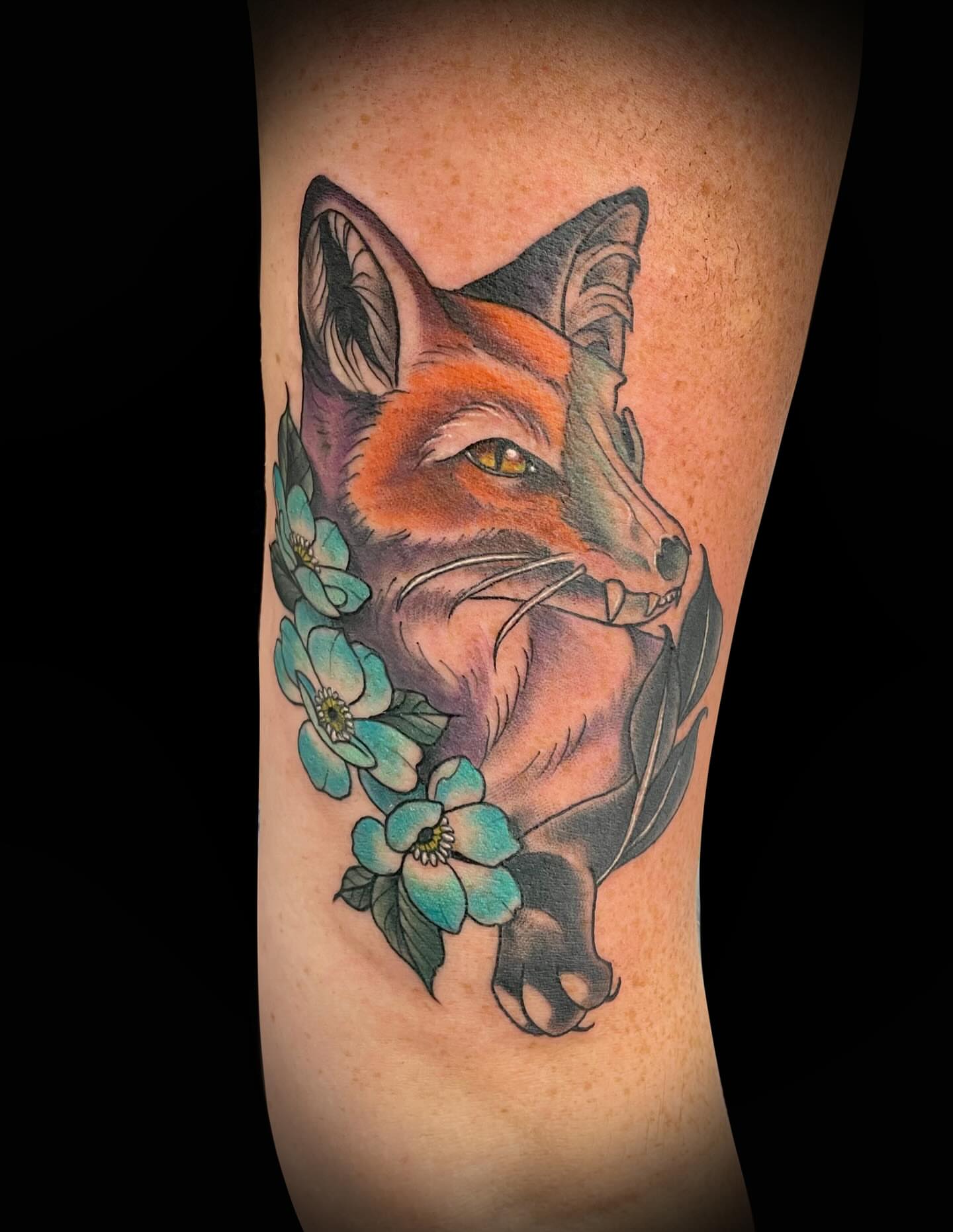 Fox with flowers realism tattoo on the forearm by Antoinette
