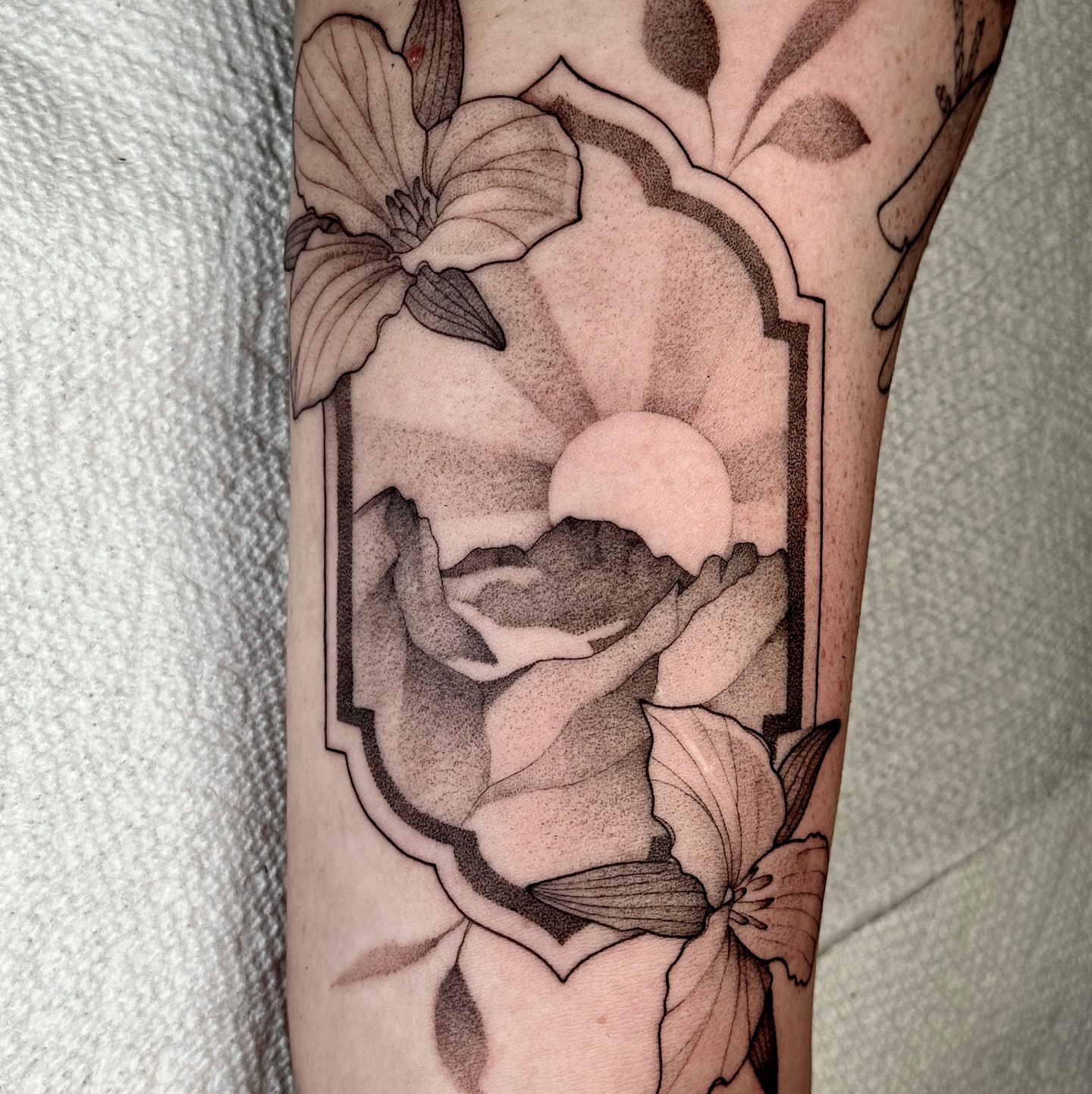 Flower and moon black and grey tattoo on the forearm by Molly Murray