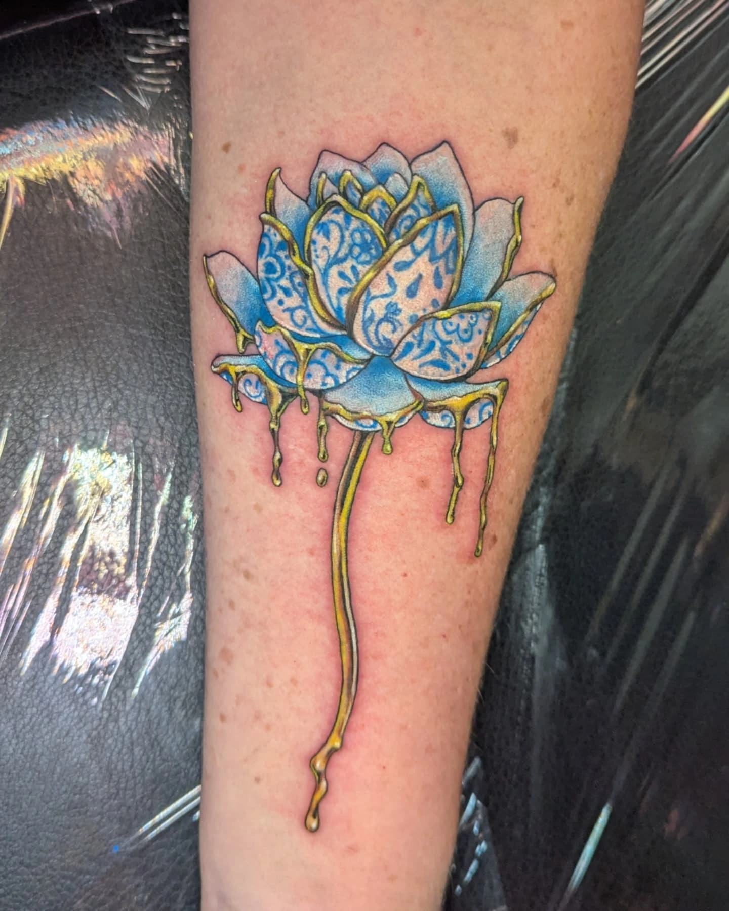 Lotus flower new school tattoo on the forearm by Bethany Jane Tattoos