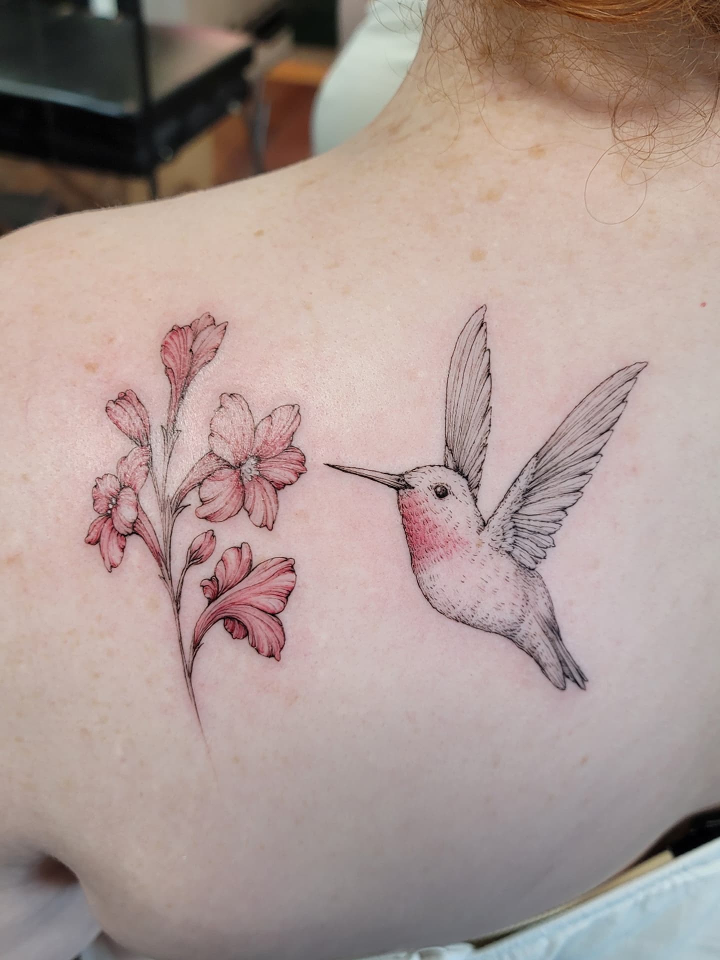 Hummingbird and flowers realism tattoo on the back by Keith Countryman, Fort Worth, Texas