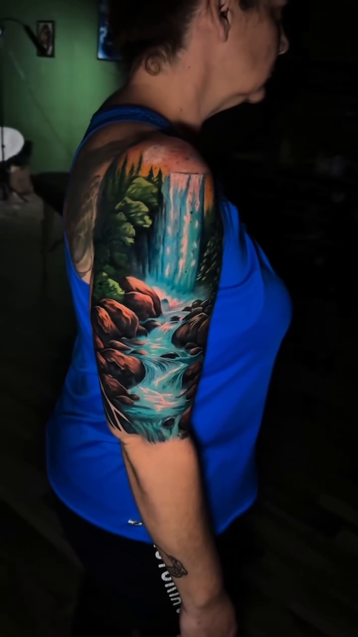 Waterfall landscape realism tattoo by Zach Ashton