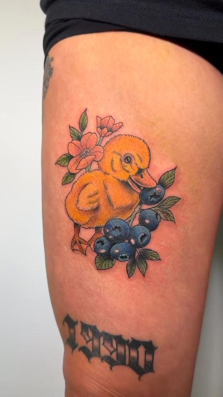 Duckling with blueberries and flowers neo-traditional tattoo by Tori Bent