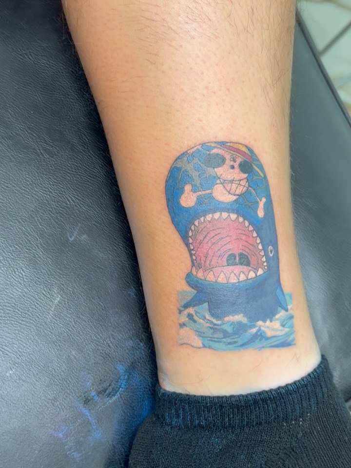 Shark with skull anime tattoo on the forearm by Melissa C, Phoenix, Arizona