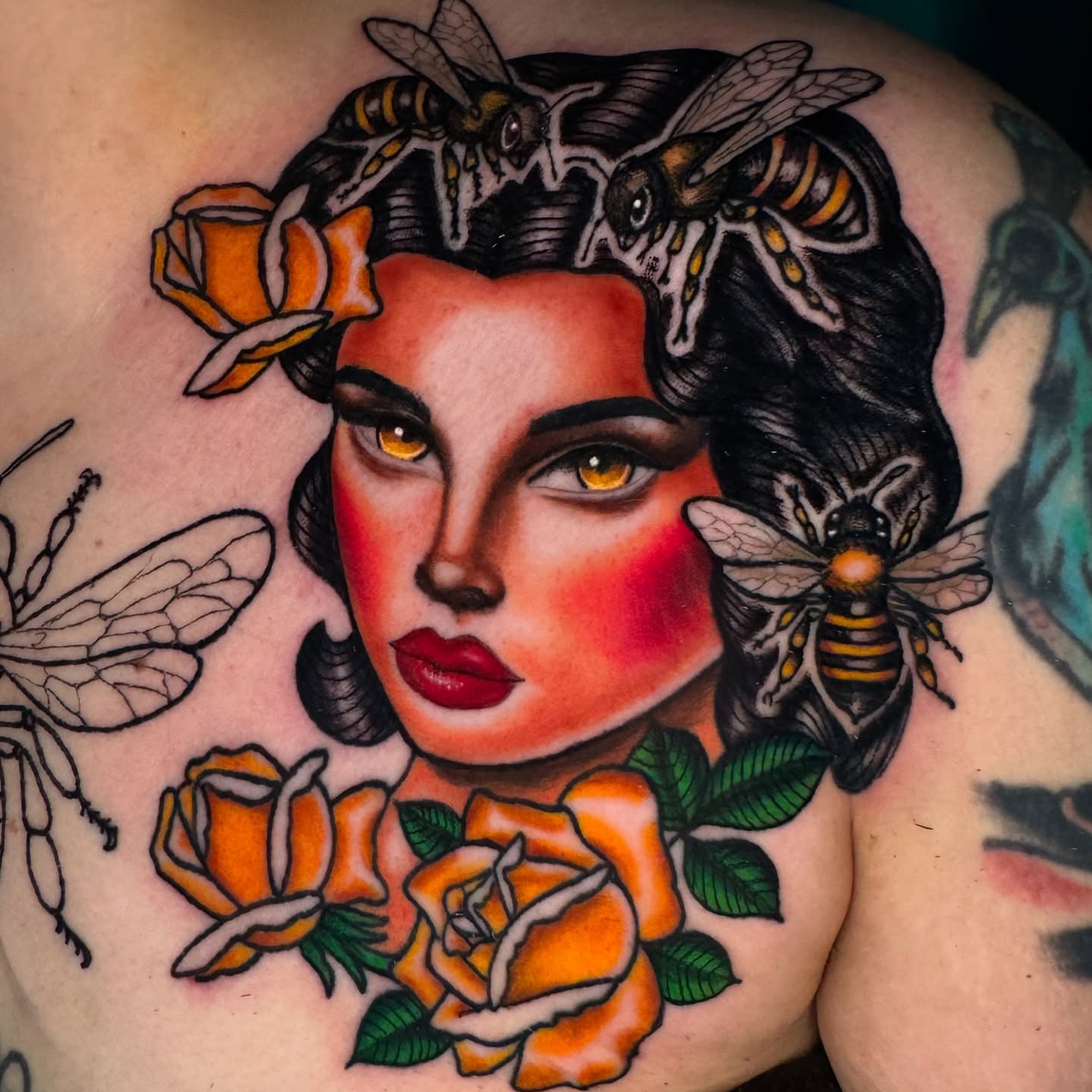 Woman with bees and roses American traditional tattoo on the chest by Lisa Del Toro