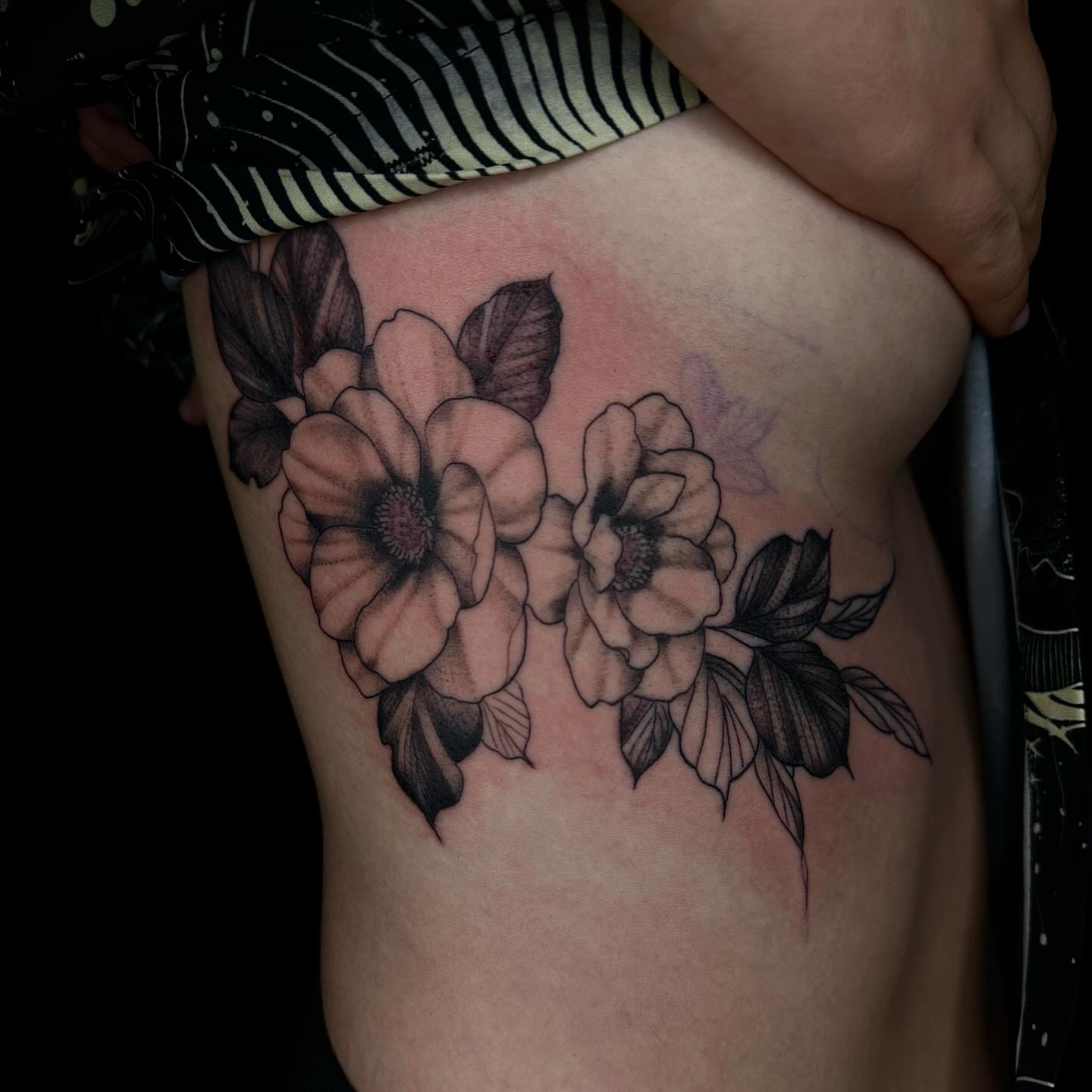 Flowers black and grey tattoo on the thigh by Jay Morales