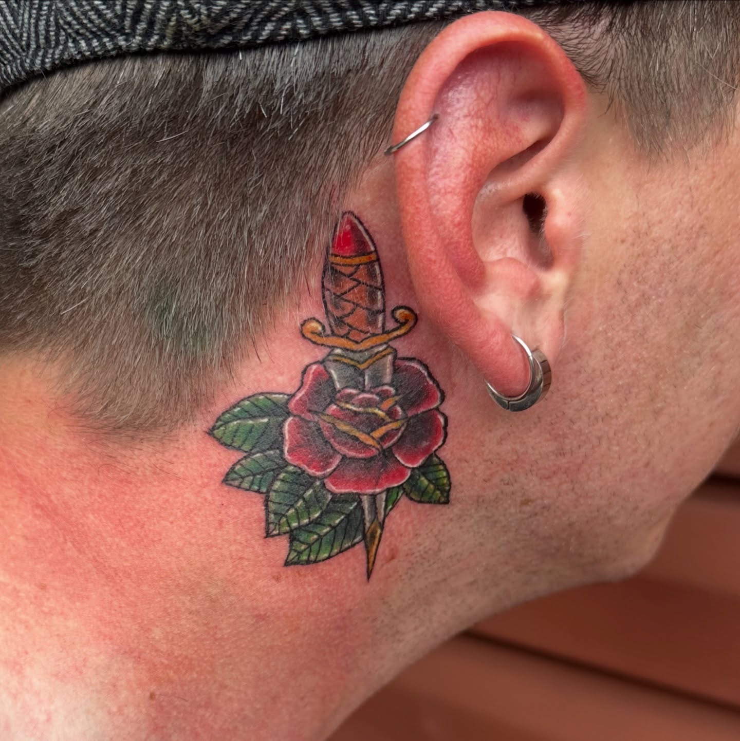 Sword and rose American traditional tattoo on the neck by Bosco Layne