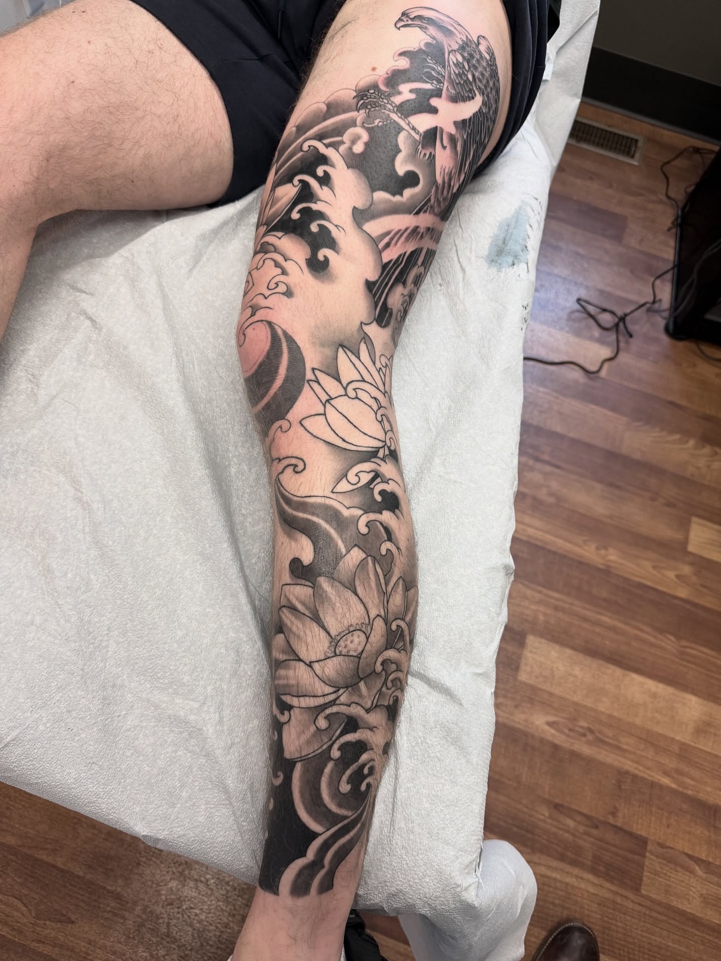Lotus flowers and waves japanese irezumi tattoo on the forearm by Jeremy Utley