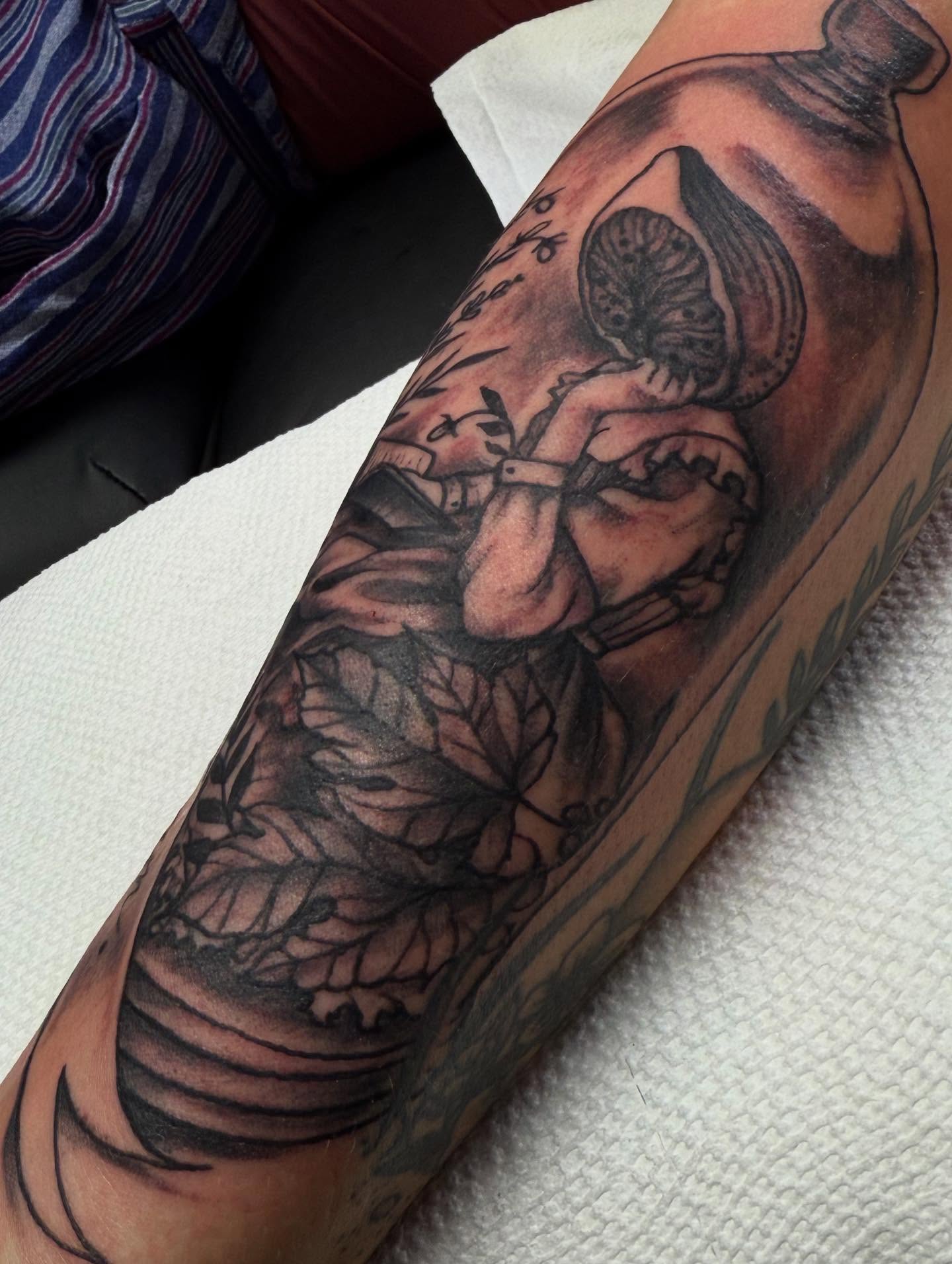 Man in bottle black and grey tattoo on the forearm by Tattoos By Trish