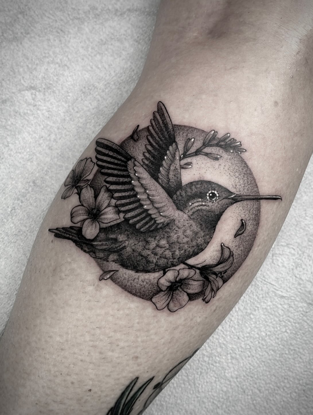 Hummingbird and flowers realism tattoo on the forearm by Martha Gual π€ East ATX Tattooer