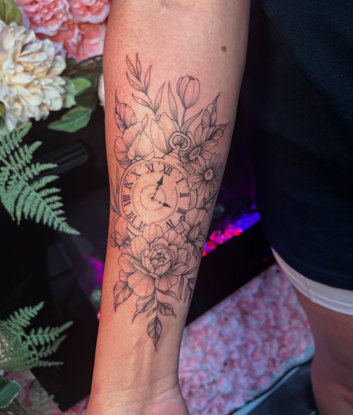 Clock and flowers realism tattoo on the forearm by π±π½πππΎπ