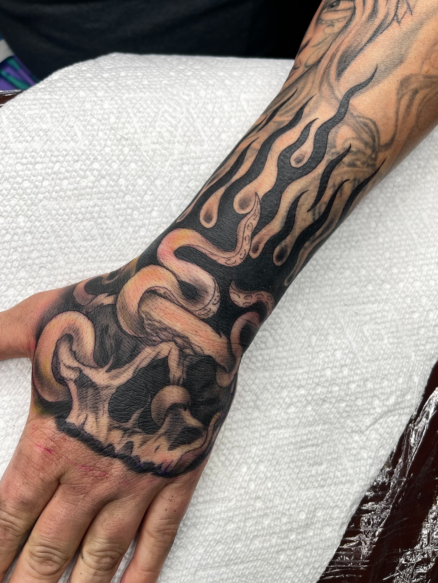 Flames and snake realism tattoo on the forearm by Blake Alan Tattoos (TROUT)