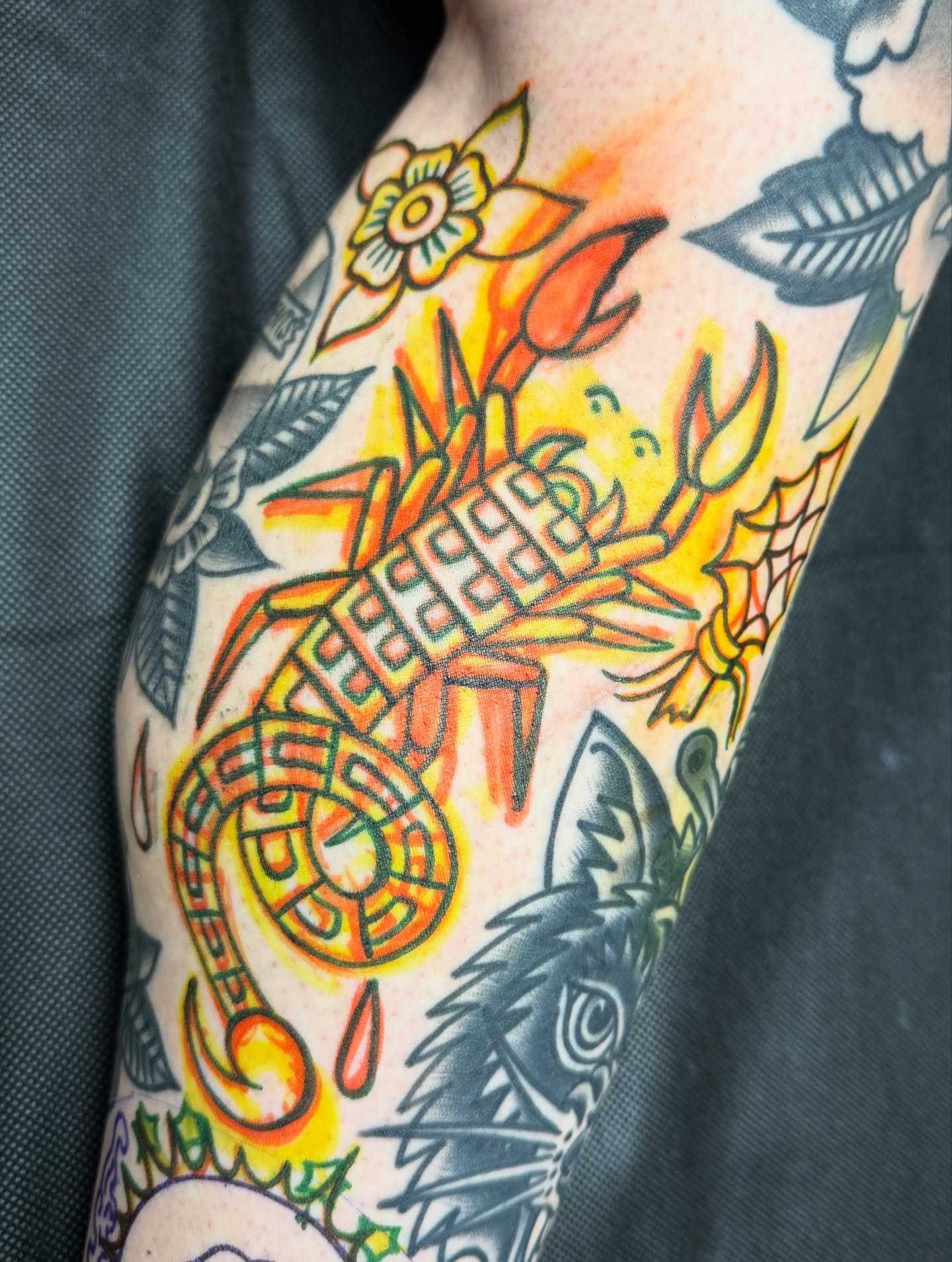 Scorpion and flowers American traditional tattoo on the forearm by Jordan Allen